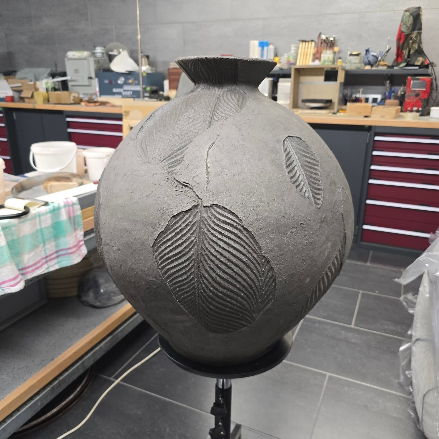 One of the pots from the workshop in France, I managed get to home (a 6 hours drive) in one piece. I decided to carve it and see where it went... This is where it went! I'm not unhappy about it. I've covered it up to dry out slowly and I will eventually glaze and fire it. Perhaps it'll be finished in December, so stay tuned ๐