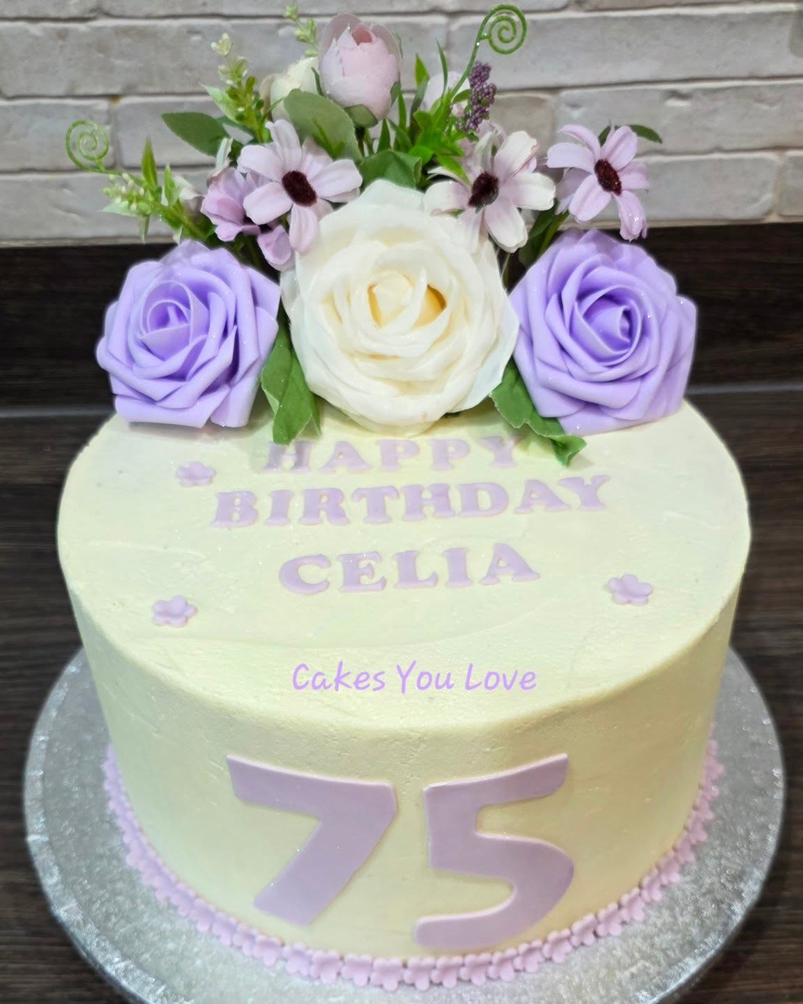 A vanilla sponge filled with vanilla buttercream and strawberry conserve. Faux flowers used for decoration