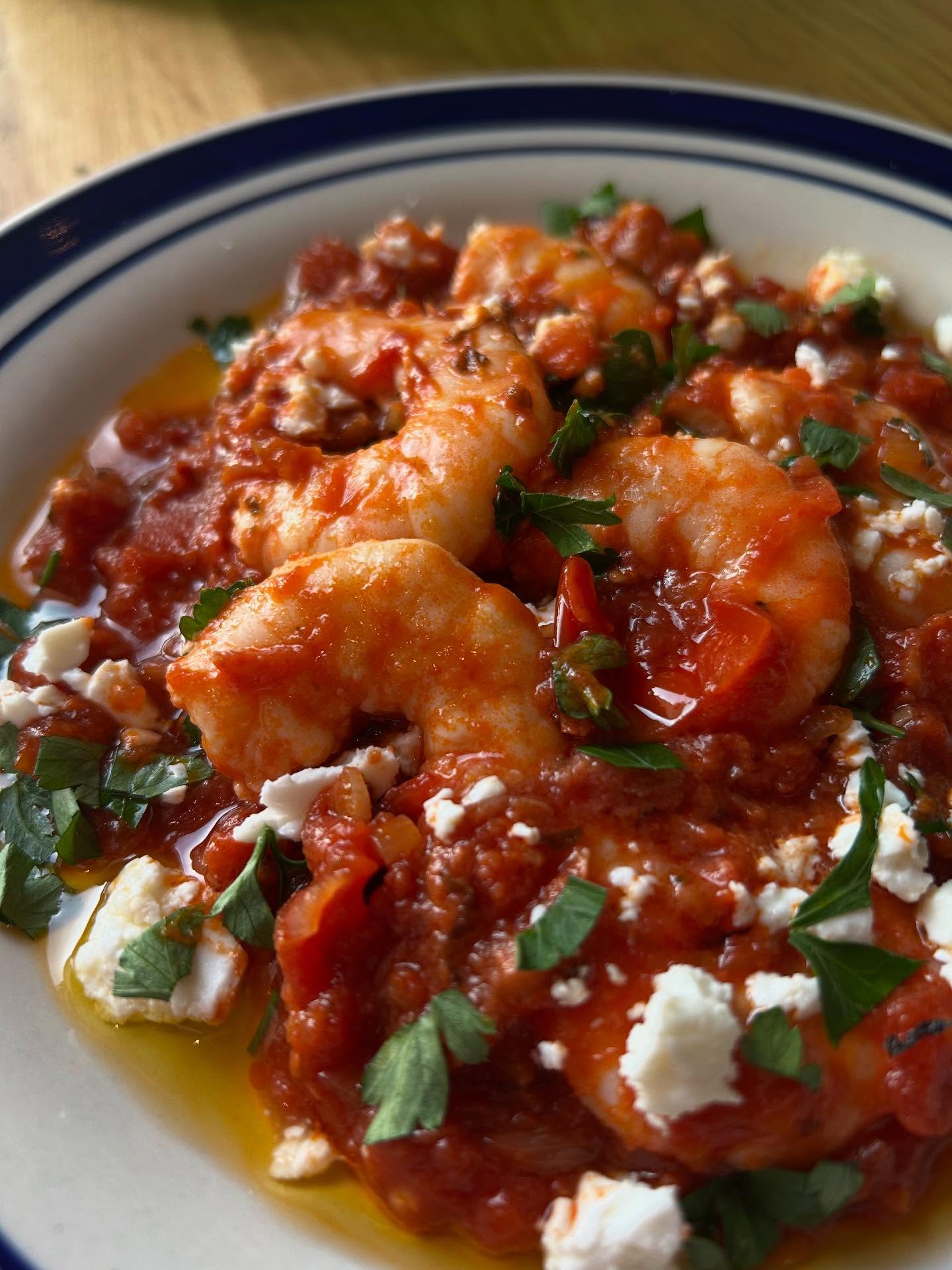 Shrimp Saganaki
After we got married, we spent two weeks in Greece. We visited a couple of
islands and then headed back to the mainland. We ended up at a beach near
Gythio, in the Peloponnese. The taverna there looked like any
other we’d been to before: lovely, but nothing extraordinary.
We ordered tzatziki with bread, dakos, and shrimp saganaki. The mezze and
salad were delicious, as always. Then the shrimp arrived: basically shrimp in
tomato sauce with feta on top. It looked simple, but the taste was
delicate and perfectly cooked. Clearly, someone there knew exactly what they
were doing.
I asked the waiter who’s responsible for that dish. He said his mum really is a great cook and pointed to the kitchen.
I did notice the chefs in tavernas were often middle-aged
women.
No tattoos, no leather knife roll, no Instagram.
This is my little tribute to them, and to that moment.
Upcoming supper club tickets in Bio x