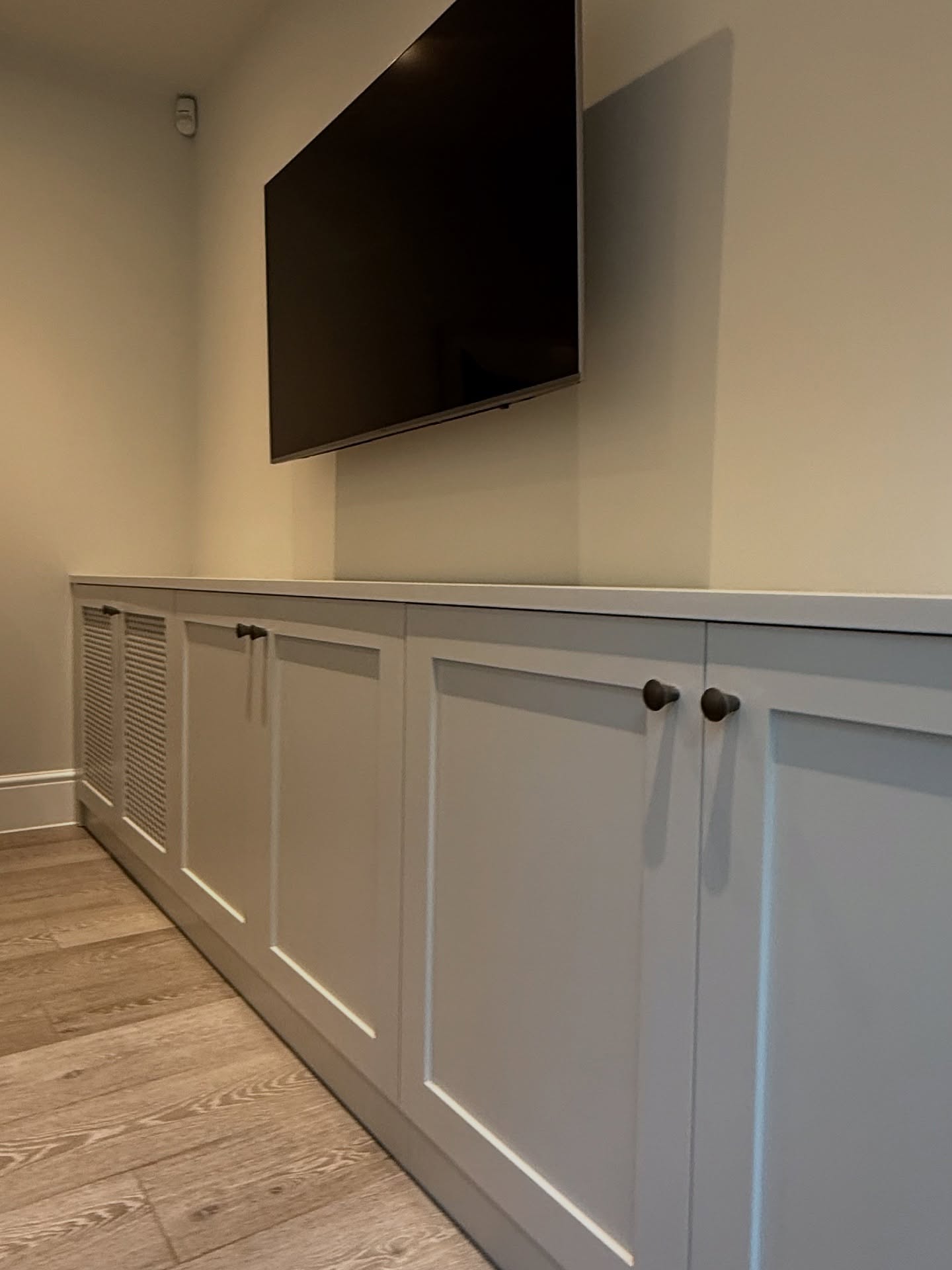 Created a media unit that hides the radiator and TV cables, painted to match the kitchen finish with Intelligent Satin French grey mid by Little Greene. Looks nice and sleek. Get in touch for your decorating and related carpentry work. #cabinetmaker #tvwallmounting #tvunit #handyman #horsham #carpentry #painting
