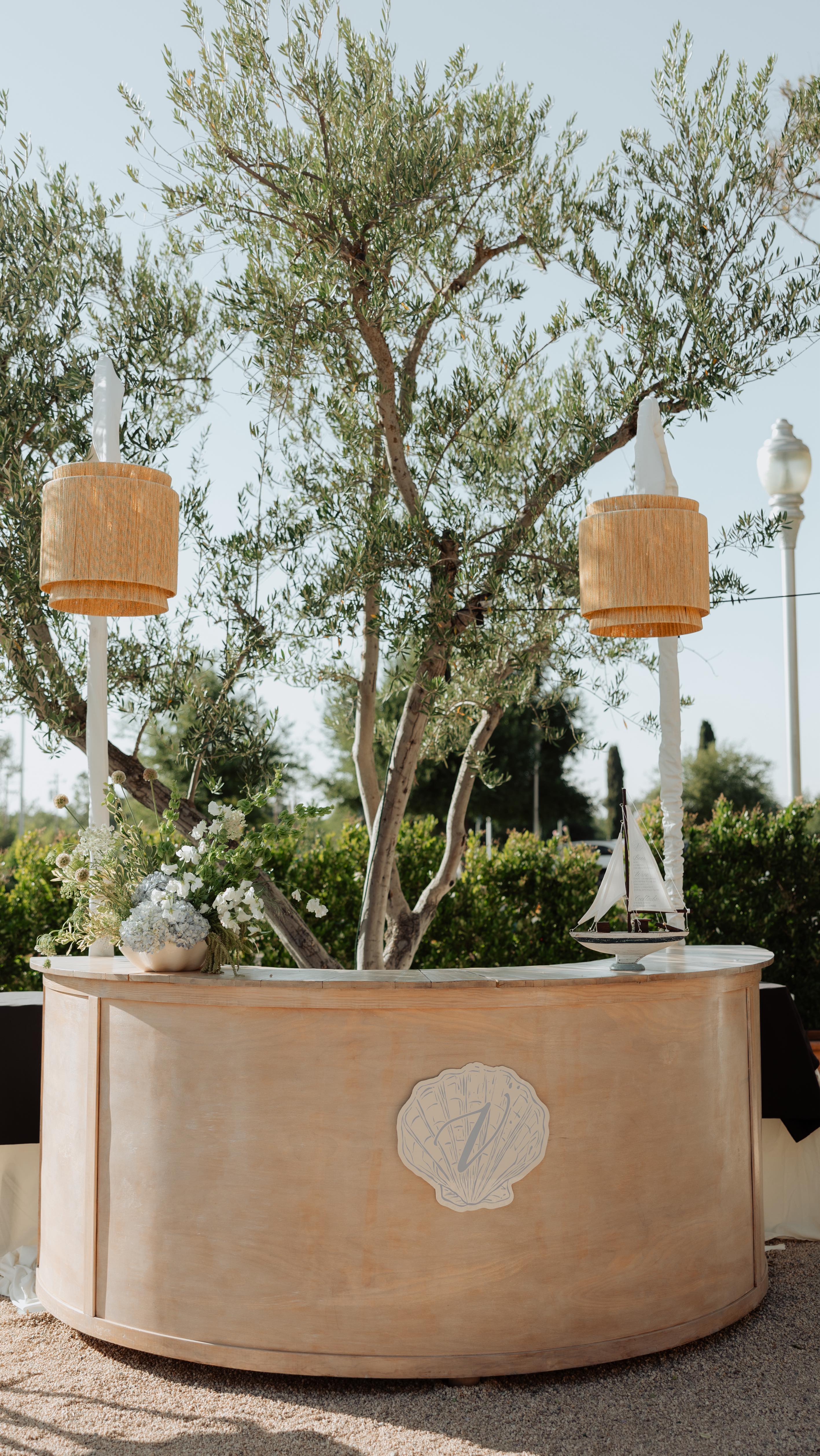 A few of our ✨favorites✨ right now:
Serpentine Tables: the shape says everything we can’t. We LOVE them. Plus, they’re versatile and can be used with other table shapes to break up a space or add a funky design element.
Merch Walls: branded merch from your wedding? “Hell yeah!”- Stockroom Girls
Unique overhead lighting: lighting sets the mood for your event, why not make said lighting pretty and/ or colorful!? Also, ditch the traditional black or white pole socks and opt for a pop of color. We offer a variety of colors options to fit your vibe.
Statement colored bars: make a statement, people. Color is IN! If you want something a little different for your event, we offer a paint change on several of our bars. Feel free to message or email us if you’re interested.
