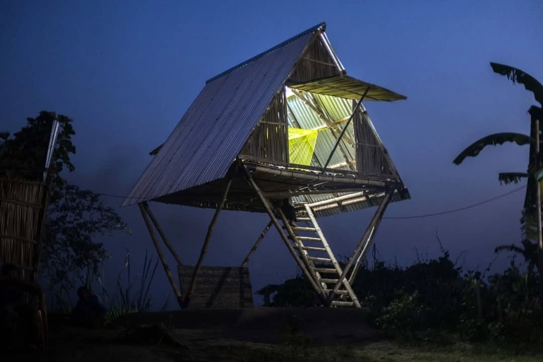 Congratulations to our DAS 2023 artist, Marina Tabassum, and her practice for receiving the Aga Khan Award (2023–2025 cycle) for the project Khudi Bari.
Khudi Bari (Bengali for “Tiny House”) is an example of design thinking and action. It is a modular, mobile home that can be fabricated for as little as 500 dollars, providing elevation to protect lives and belongings in the wake of flash floods on tiny “desert islands” of sand, known as chars, scattered across the Bengal delta. Land in Bangladesh’s floodplains is fluid—these islands often erode or break off into the water—making it necessary for families to physically move their homes when the ground beneath them disappears.
Tabassum’s design draws on the traditional architectural language of the Bengal delta to create modular, mobile housing units that are low-cost, durable, and quick to assemble or dismantle with minimal labor. Built with a rigid space-frame structure, Khudi Bari demonstrates how locally rooted knowledge can inspire innovative solutions for uncertain futures.
Photos 1 & 2: Marina Tabassum Architects
Photo 3: Khudi Bari structure, Dhaka Art Summit 2023
@dhakaartsummit
@samdaniartfoundation
@nadiasamdani
@rajeebsamdani
@dhakadiana
@rux_q
@marinatabassum
@agakhanawardforarchitecture
@swilin_haque
@sazzad1985
@iftekharnoor
#dhakaartsummit #samdaniartfoundation #dhaka #sylhet #art #artwork #DAS #exhibitions #contemporaryart #srihatta #artistresidency #sculpture #SAF #marinatabassum #agakhan