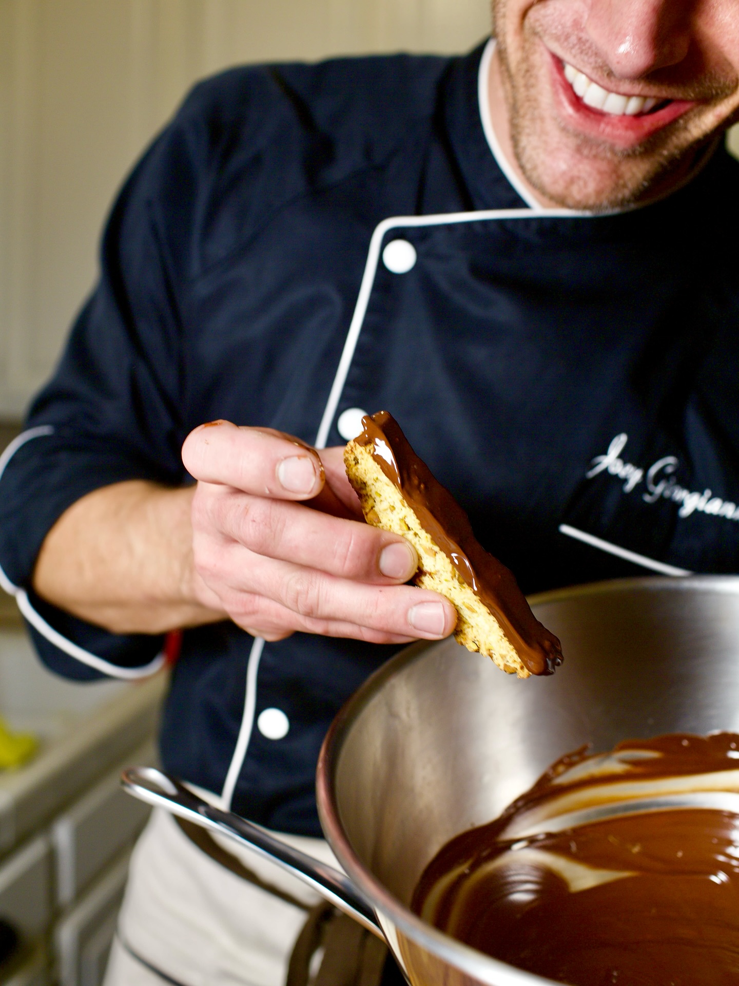 Fire up the cappuccino machine because nothing goes better with a cup of coffee than house made biscotti. Here’s my secret recipe:
Traditional Chocolate-Dipped Biscotti
Ingredients: 🍯
2 cups all-purpose flour
1 cup granulated sugar
3 large eggs
1/2 cup unsalted butter, melted
1 teaspoon vanilla extract
1 teaspoon baking powder
1/2 teaspoon salt
3/4 cup whole almonds, roughly chopped (optional)
For the chocolate coating:
8 oz dark or semi-sweet chocolate, chopped
2 tablespoons coconut oil or shortening (for smooth dipping)
Instructions
Making the biscotti:
Preheat oven to 350°F (175°C). Line a baking sheet with parchment paper.
In a large bowl, whisk together flour, baking powder, and salt.
In another bowl, beat eggs and sugar until thick and pale (about 3 minutes). Add melted butter and vanilla.
Gradually fold the dry ingredients into the wet ingredients until just combined. Fold in almonds if using.
Divide dough in half and shape into two logs about 12 inches long and 3 inches wide on the prepared baking sheet.
Bake for 25-30 minutes until golden and firm to touch. Cool for 10 minutes.
Using a sharp serrated knife, slice diagonally into 1/2-inch thick pieces. Arrange cut-side down on baking sheets.
Bake again for 10-15 minutes, flip, then bake another 10-15 minutes until crisp and dry. Cool completely.
Chocolate dipping:
Melt chocolate and coconut oil in a double boiler or microwave in 30-second intervals, stirring until smooth.
Dip each biscotti halfway into chocolate, letting excess drip off. Place on parchment paper.
Let chocolate set at room temperature for 30 minutes or refrigerate for 10 minutes.
Store in an airtight container for up to 2 weeks. The double-baking process creates that characteristic dry, crunchy texture perfect for dunking in coffee! And that’s the Chef Joey biscotti breakdown ;)