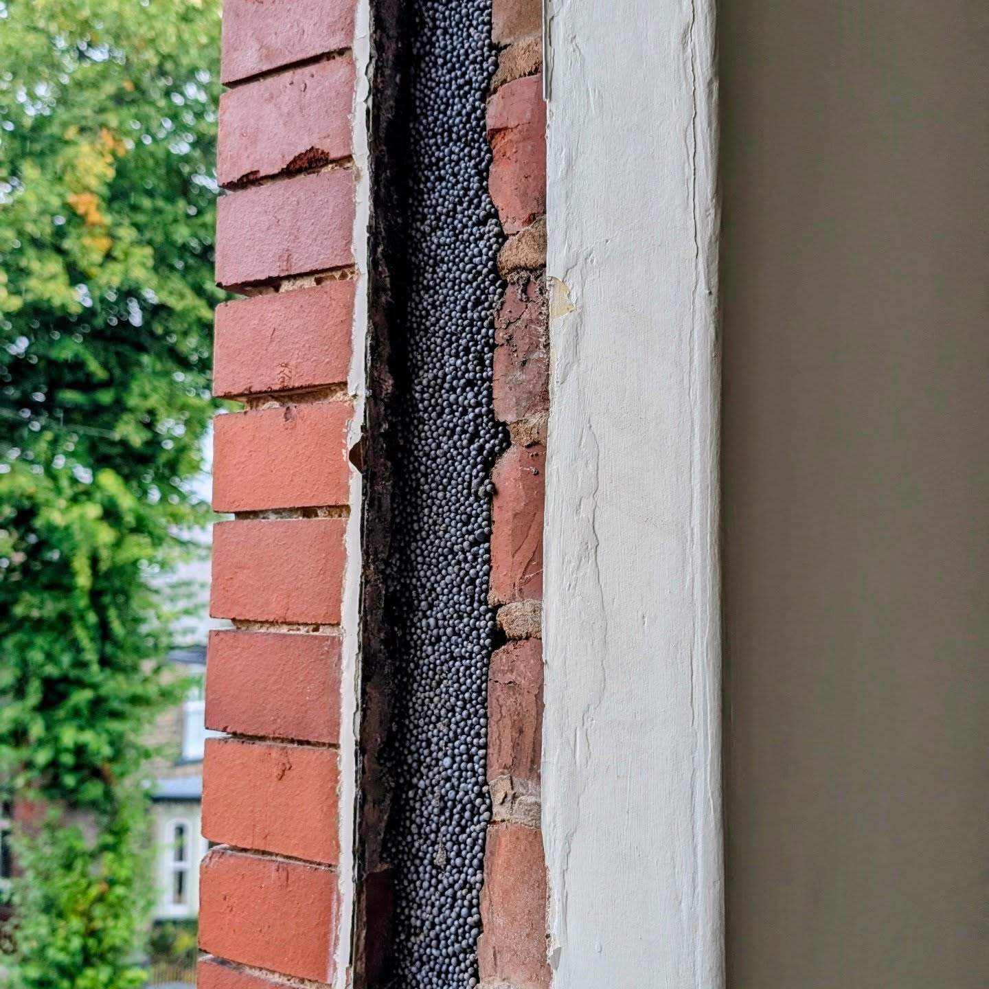 Retrofit cavity wall insulation filled to original window reveals.