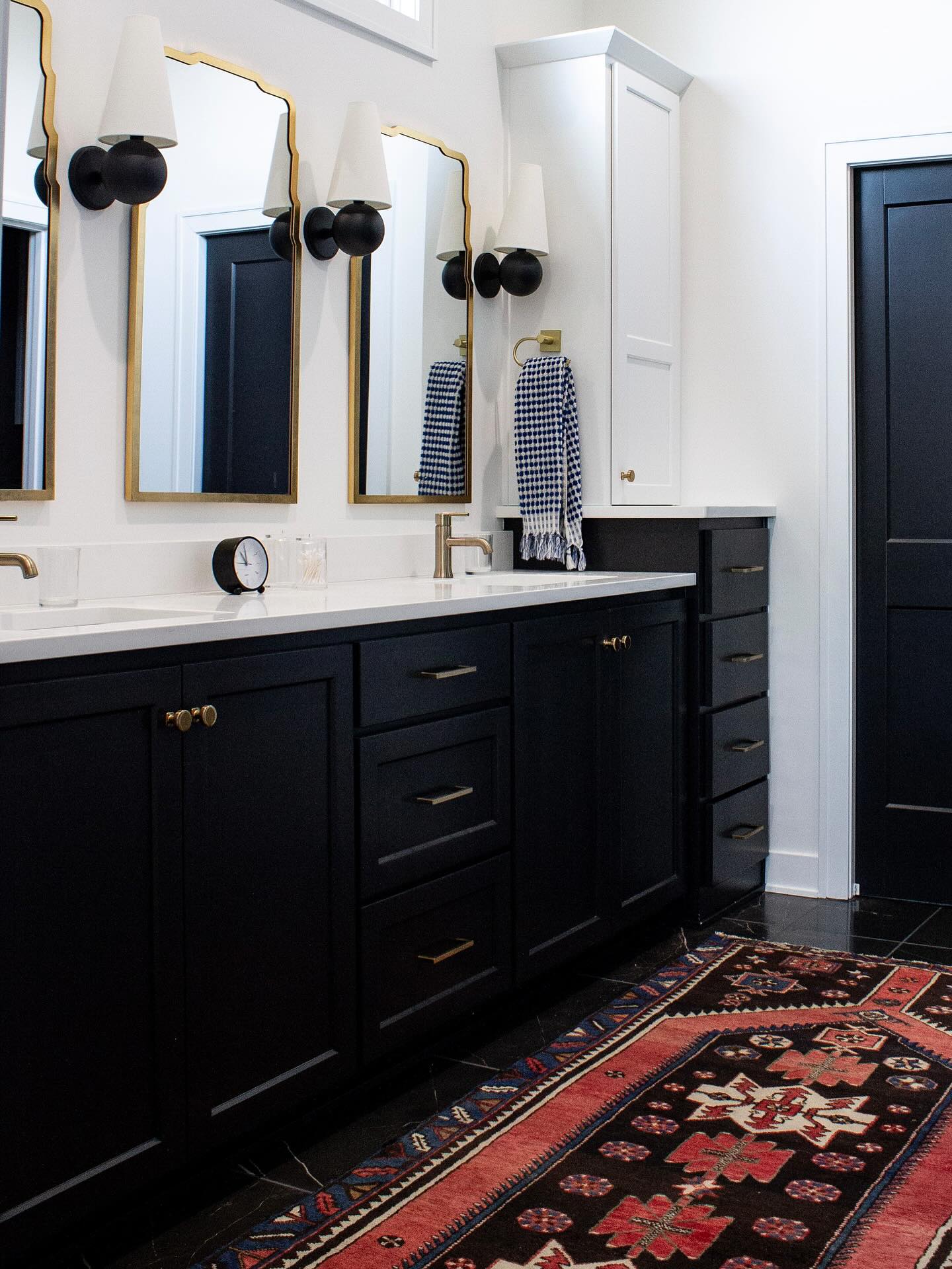 This bathroom was part of a new build that my clients brought me in to help with from the jump. I love working with builders open to new ideas. I changed the lighting and its placement, color scheme, and finish selection to reflect my clients taste. I also added a third mirror to make the design more interesting and modernize it. The rug adds color and a one of a kind vintage vibe that offsets the super modern finishes and color palette, which gives it more of an eclectic feel. Love it!
Interior Design: @nicholeloiaconodesign
Builder: @mcgraw_homes
#kcdesign #kcinteriordesign #kchomes #kansascitystyle #kansascitydesign #kcdesigner