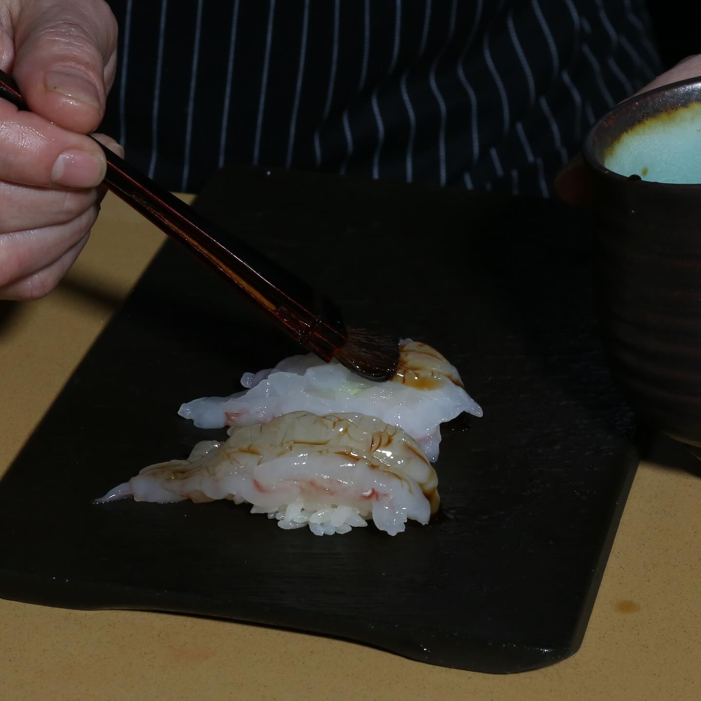 It’s not about how much, but where and how. A gentle brush of soy sauce that is subtle, controlled, and perfectly placed.