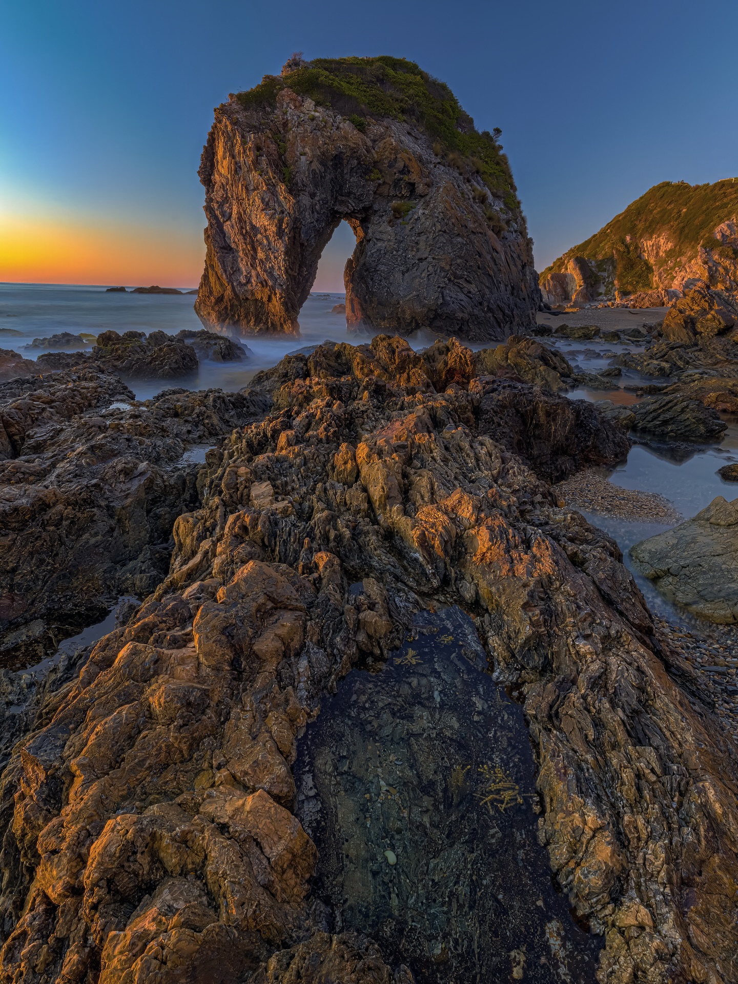 Horse Head Rock, doing its best impression of a prehistoric unicorn that lost the rest of its body sometime around half a billion years ago. 🐴🌊
No cloud’s unfortunately, Just me, @rachelmelissa.21 in spirit, a tripod, and a rock that’s been photographed relentlessly. Honestly, it’s been done better, by better. But Instagram hasn’t banned reruns yet, so here’s mine 🤣.
What you don’t see: the death-defying slip-n-slide to get here. Those boulders? Gnarly. The tide? Luckily running out but it could easily audition for a disaster movie. You don’t just walk to Horse Head Rock — you negotiate with Poseidon.
So yeah, if the photo doesn’t impress you, at least be impressed I didn’t end up floating unconscious in part of the rockpools 😉.