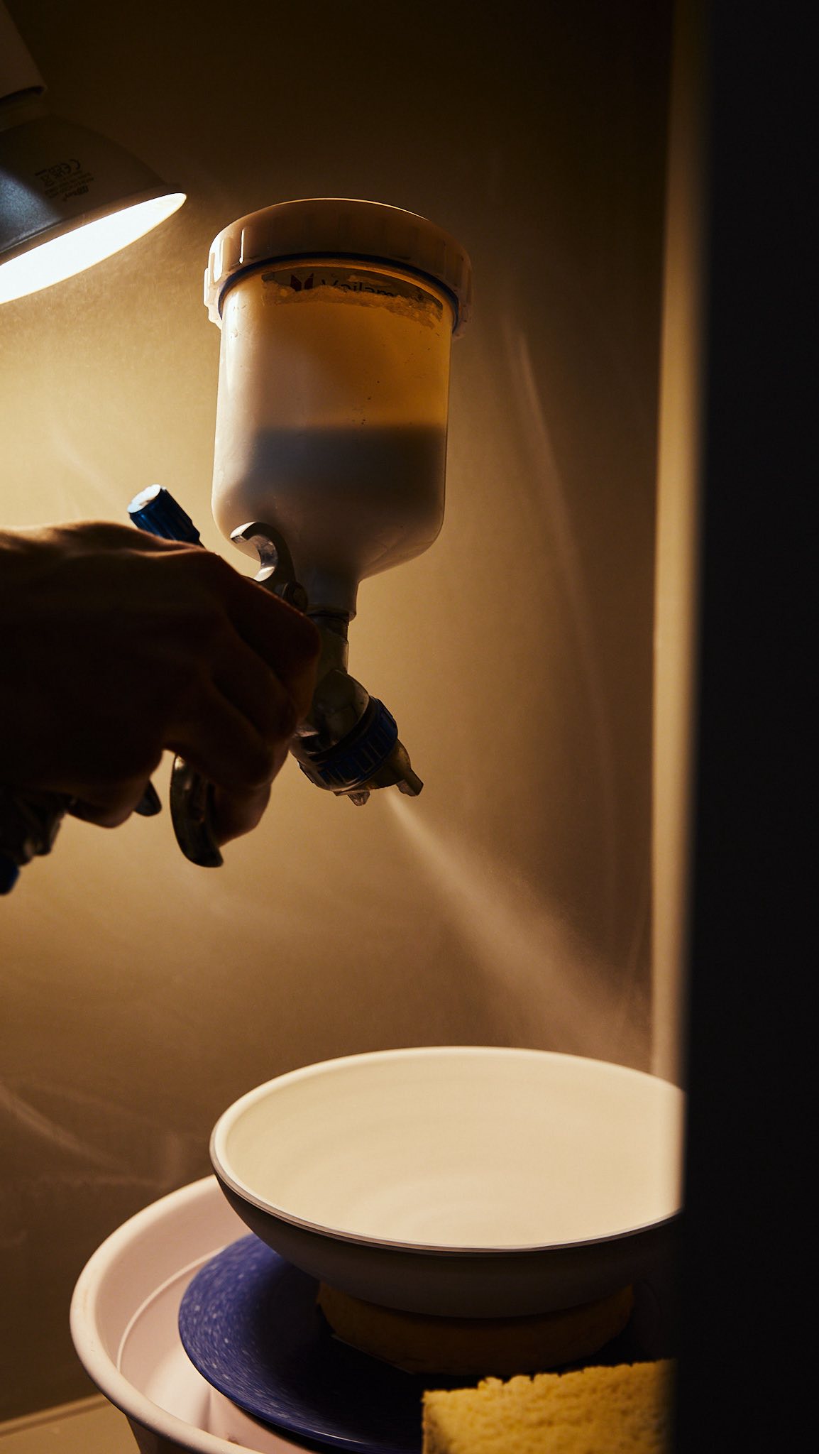 A behind the scene view of our glazing process. We have been spray glazing for 4 years now and most of our dinnerware are spray glazed, with the exception of smaller pieces and mugs. We either dip these or use a glaze pump.
Spray glazing allows for a more consistent result and smoother finish. It is in most cases faster because you avoid waxing the bottoms and cleaning all the drips that come with dipping or pouring glaze on a plate. It works great for larger pieces too!
You will definitely need a spray booth and a mask to do this as well as an air pump and a spray gun. Not an extremely expensive set up but if you opt in for the best spray gun and the best spray booth then that might get a bit expensive. I guess it depends on how many items you make a day. For us spraying glazing made sense and it was time saving with amazing results!
#handmade #dinnerware #sofiaceramics #london #pottery #pottery #bts #plates #bowls #glazing