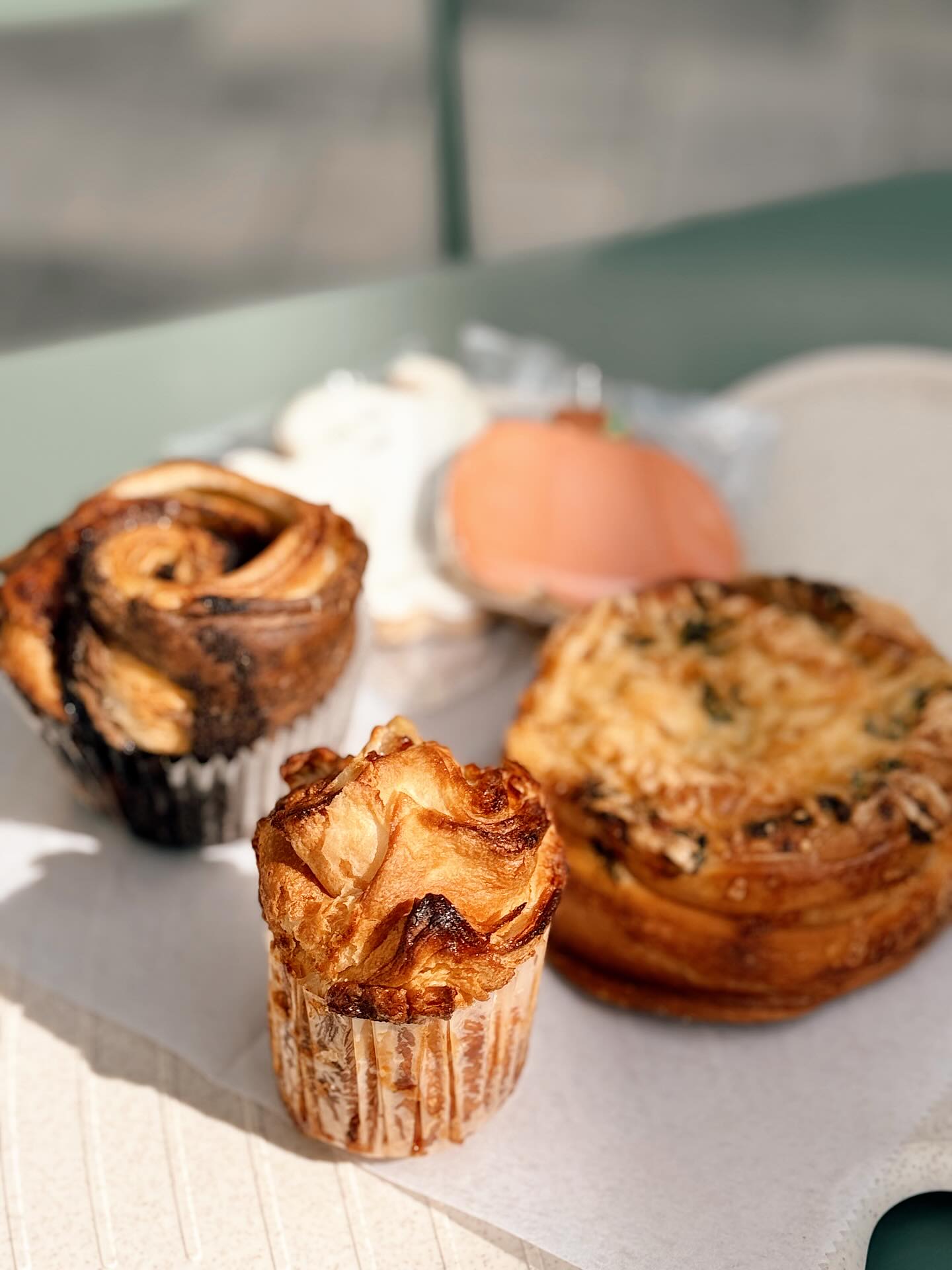 PUMPKIN ROLLS ARE BACK! 🎃🍂
It’s cooling down, but the kitchen is heating up! (Literally though, our air conditioning went out last week, thanks for everyone’s patience while we got that fixed 😅)
The seasonal faves are BACK and some new surprises in store for the season!
Pumpkin Rolls (ofc)
Apple Kouign Aman
Wild berry Cheesecake Cinnamon Rolls
Black Velvet Morning Buns
Monster rice crispy bars
Ghost and Pumpkin Sugar cookies
Black rose Meringue Pops
GF Apple filled Coffee Cake Muffins
+ New Macaron Flavors✨
We also have new fall drinks!
The one pictured is our Wednesday Adam’s Ube Chocolate Latte