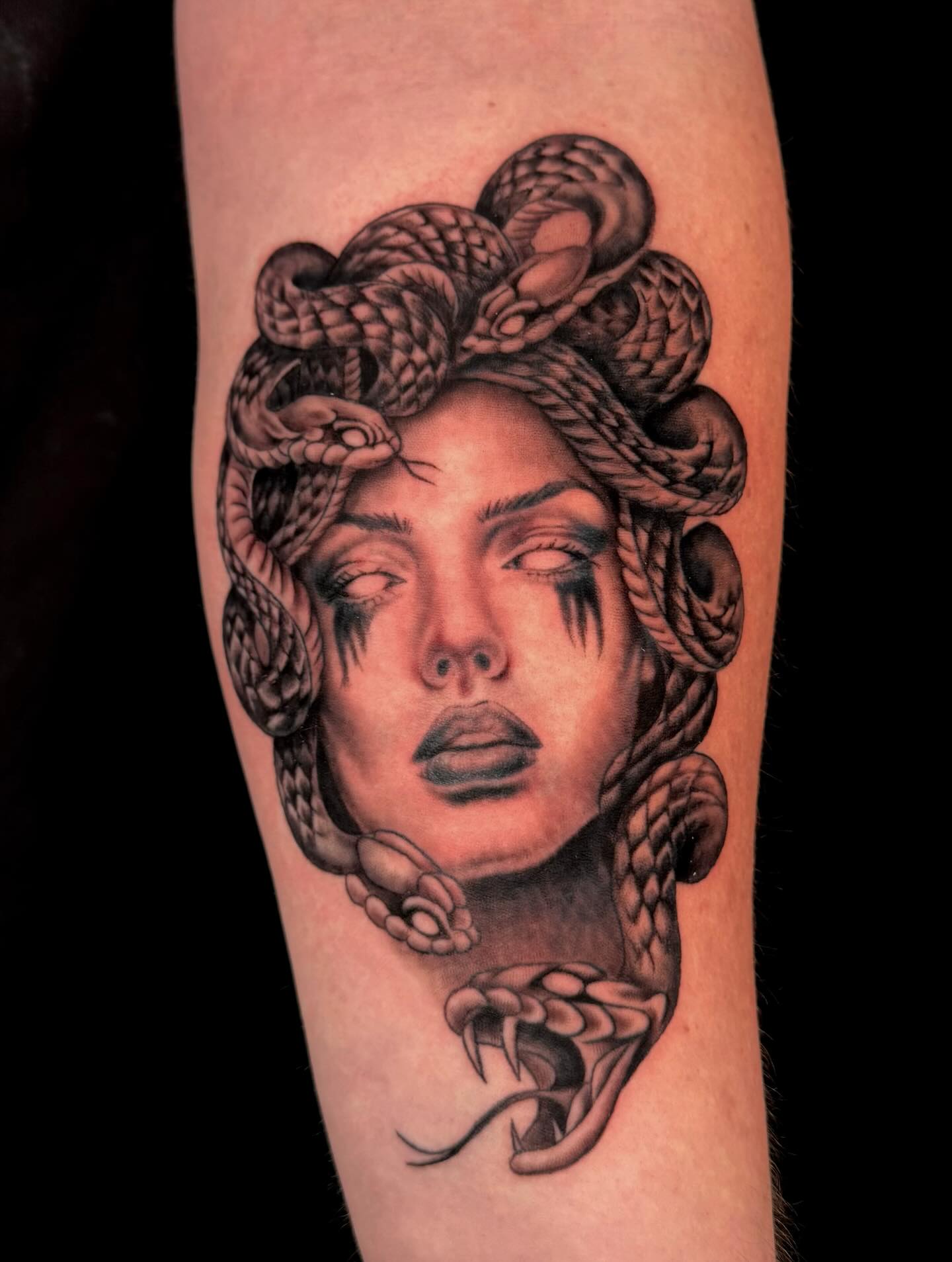 My first Medusa tattoo! Started in May 2025 and finished June 2025 :) Thank you Fabian!
Learning Moment #1: As a new tattoo artist, one of the first things I grappled with was the extremely scary concept of complete self-reliance. Before tattooing, I worked in the corporate world where I was paid a handsome salary topped with health & wellness benefits, meal & travel perks, 401K contributions, and even a pension. If I took 2 weeks off from work, I knew my paycheck would still hit my account. If I got sick, I knew my insurance would cover it. It was safe, predictable, and comfortable to say the least. 
This new life as a tattoo artist is completely different - no benefits, no health insurance, and no guaranteed measure of income. If I don’t work, I don’t make a dime. If I get sick, I pay out of pocket. The safety net I had before is no longer there, and sometimes it feels like I’m completely exposed and at the mercy of happenstance. No one is deciding what my annual raise or salary should be - it’s up to ME every single day to make this living. 
I will admit, when I was doing free tattoos at the beginning of my apprenticeship, all of these changes were always heavy on my mind. 
“What if I’m no good at this?”
“What if no one books with me?”
“What if I can’t pay the mortgage?”
“What if I get really sick?”
A year later, and most of these fears have completely dissipated (the only thing I’m still worried about is getting really sick 😂). I can hardly believe it whenever I say this, but y’all, I’m currently 7 months booked out and still booking 😭🙏🏼 There are over 150 of you waiting to get tattooed by me, and that’s absolutely insane. I couldn’t be more grateful - I wake up every single day excited to tattoo and meet new clients. I’m so thankful for this life and I’m gonna stop writing now before I start crying about it again. 
TLDR: The trade offs and risks are 100% worth the happiness of being a tattoo artist. 
#tattoo #tattooartist #arizonatattoo #arizonatattooartist #femaletattooartist #ink #inktherapy #tattooideas #blackandgreytattoo #blackandgreyrealism #medusatattoo