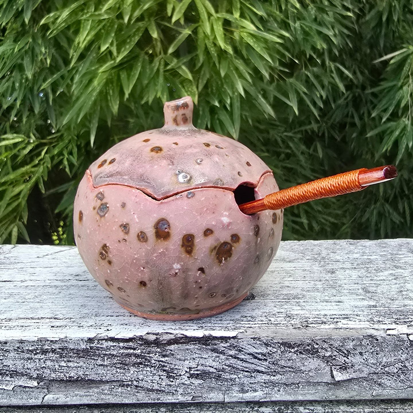 I hadn't tried to make a sugar pot from this pink clay because I can't carve it without destroying my tools, and i didn't think a smooth version would be as nice. I gave it a shot to see what would happen and I'm not disappointed. I used my new glaze, but in a different atmosphere to the whiter version of it. I'm not disappointed with the result. The blooms of iron that bleed through the clay add interest to the piece and the glaze has a lovely purple-red blush.