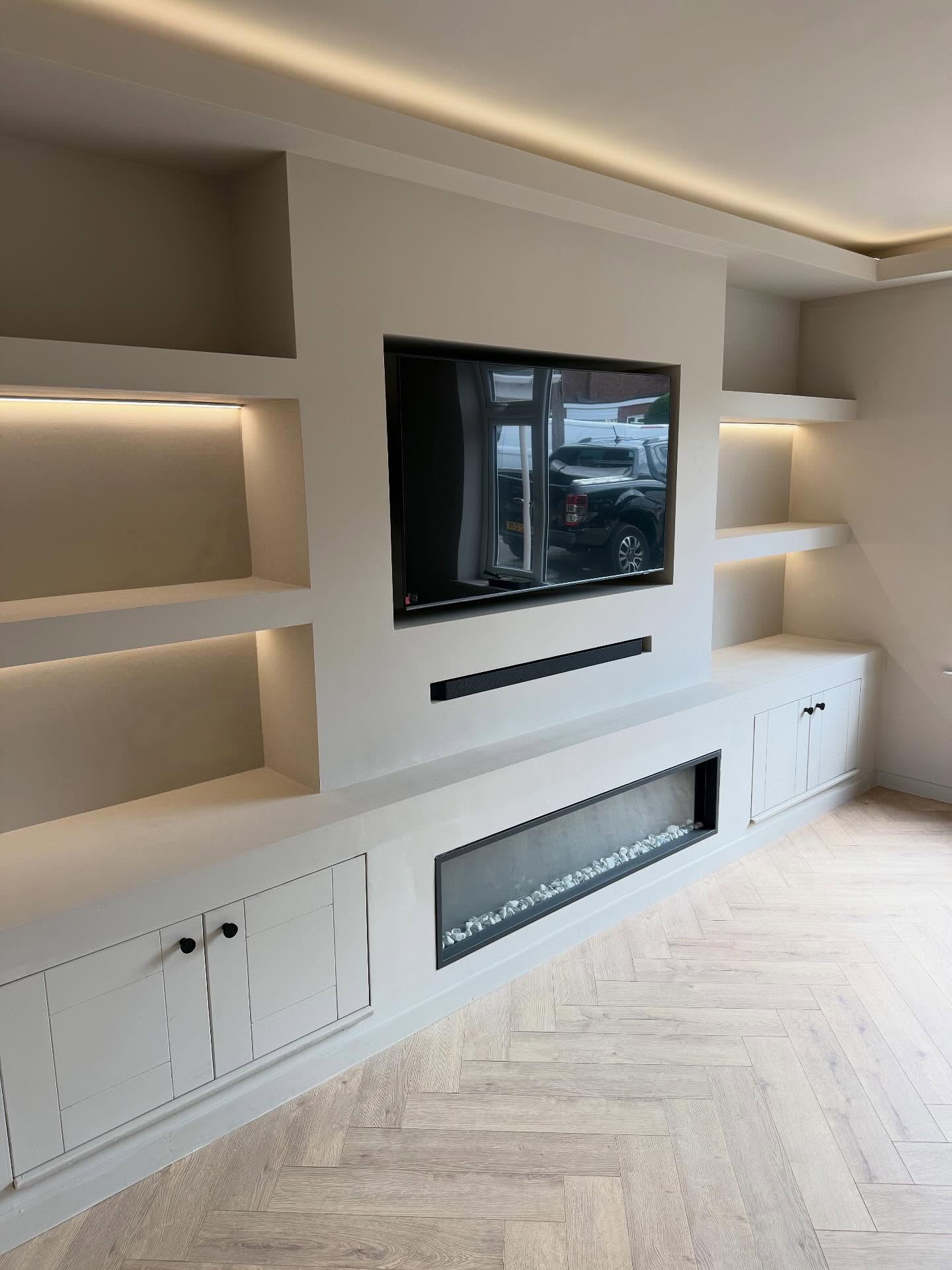 Custom designed media wall install with fully integrated fire place and LED lighting. We also built in coving around the room with built in LED light strip, it also didn’t end there as we installed sliding glazed pocket doors