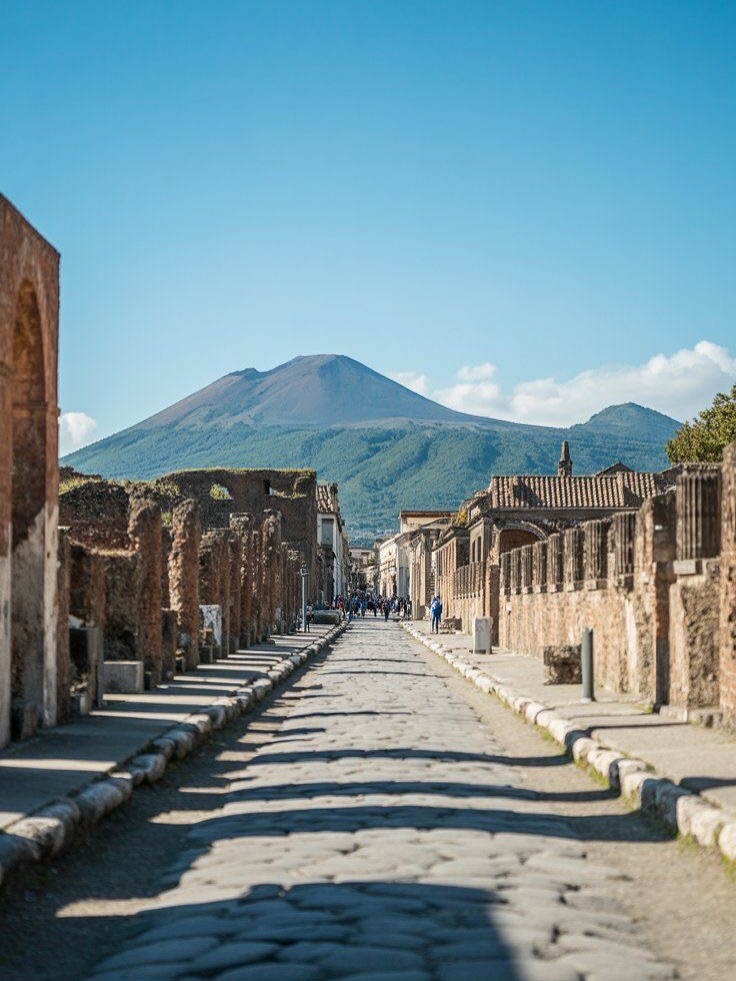 Pompeii and Pizza in Naples
Discover the wonders of ancient Rome and the flavors of modern Italy on this unforgettable full-day adventure to Pompeii and Naples. Your English-speaking guide will greet you in central Rome and escort you onto a high-speed train headed south through the Italian countryside.
In just over an hour, you’ll arrive at the sun-drenched slopes of Mount Vesuvius, the volcano that forever changed history with the eruption that buried the Roman city of Pompeii.
Step into a city frozen in time.
With your guide, explore the world’s most unique and best-preserved archaeological site—from ancient theatres and marketplaces to Roman bathhouses, taverns, and brothels. Walk the same stone streets once tread by senators, merchants, slaves, and gladiators. Learn how the people of Pompeii lived, worshiped, and governed, and come face-to-face with the haunting plaster body casts of Vesuvius’s victims, a powerful reminder of nature’s might.
After the ruins, it’s time to refuel and celebrate the flavors of Campania. We head into the heart of Naples, the vibrant and chaotic birthplace of pizza. Grab a table at a local pizzeria and sink your teeth into a true Neapolitan pizza, fresh from a wood-fired oven and made with the simplest, most perfect ingredients. While you eat, soak up the energy of this unforgettable city where history, passion, and flavor are alive on every corner. After lunch, enjoy a bit of time to take in Naples’s lively street life or grab a coffee before boarding your high-speed train back to Rome.
Click the link in the bio to know more!