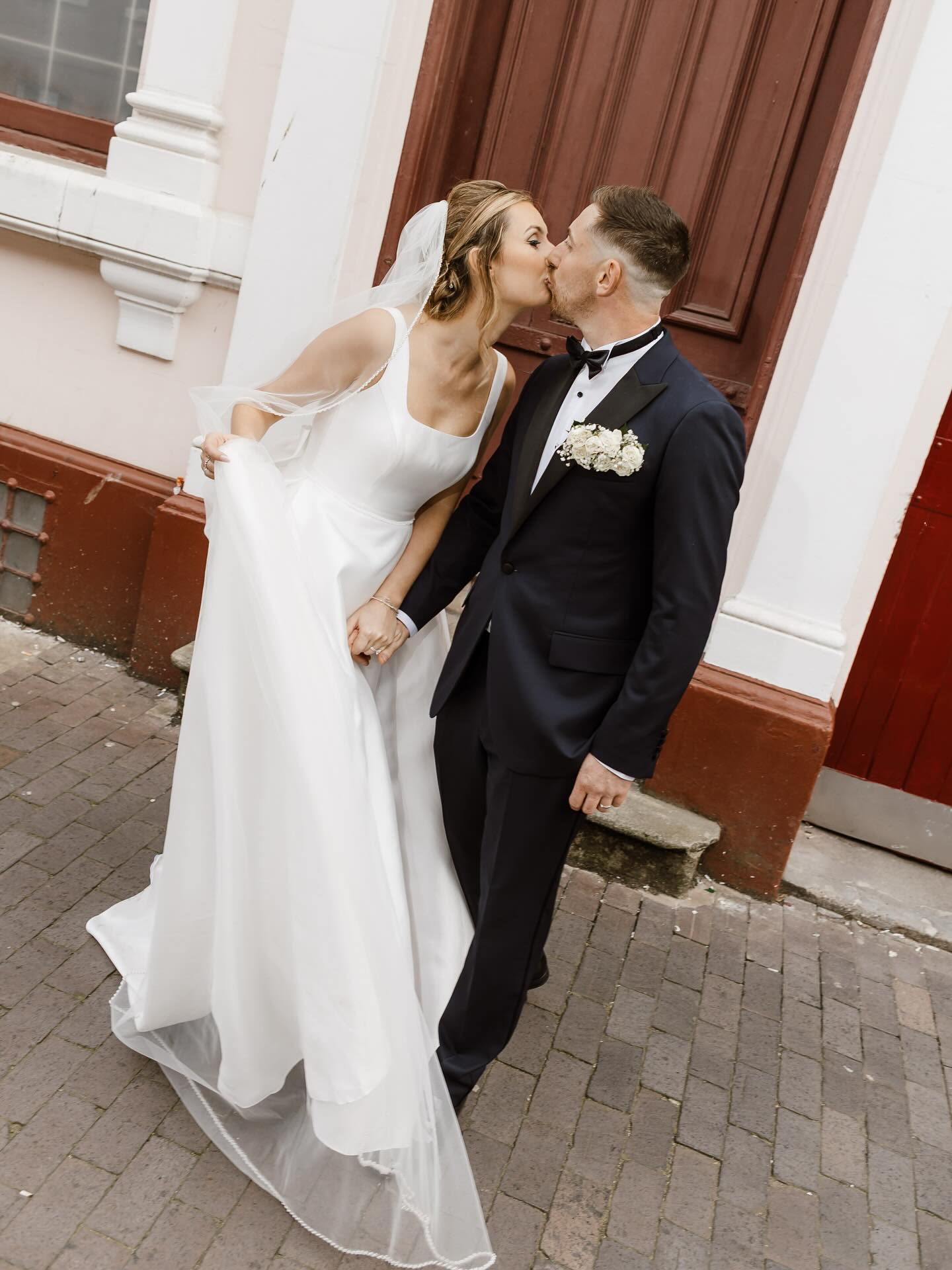 I’d like everyone to know Beth had a mini skirt put in on her dress.
Now we have that square, we can talk about the day. Beth and James ran about the Jewellery Quarter like there was no tomorrow and their energy from start to finish, was immaculate. I’m curious to know how they nailed the sheer excitement whilst also being incredibly chill; their personalities compliment each other perfectly.
All of their guests had the greatest time and their day was a whirlwind of fun, colour, and joyous friendship. These two show their warmth at every second and with their hearts on their sleeve, everybody fed off this. The cosy events space of the @buttonfactorybirmingham (I’ve drank there on many occasion) really came to life with a wedding up on the terrace and I loved the fluidity and movement of the day which really lit up my photography. They really are such wonderful people.
On a personal note, it was brilliant to work with Lindsay (@worcestershireweddingplanner )a wedding planner who is simultaneously there and not there on the day, the kind of presence that really supports the couples on a Wedding.
Also, please enjoy the clean lines and aesthetic of their outfits against the industrial Jewellery Quarter and Sandwell Registry Office, which set me off a treat.
Planner: @worcestershireweddingplanner
Venues: @buttonfactorybirmingham @sandwellregisteroffice
Dress: @whiteboutique29
Confetti: @flutterdarlings
Cake: @flowersandcakes_by_sophie
Band: @jessicarhodesmusic
DJ: @edsteelefoxthedj