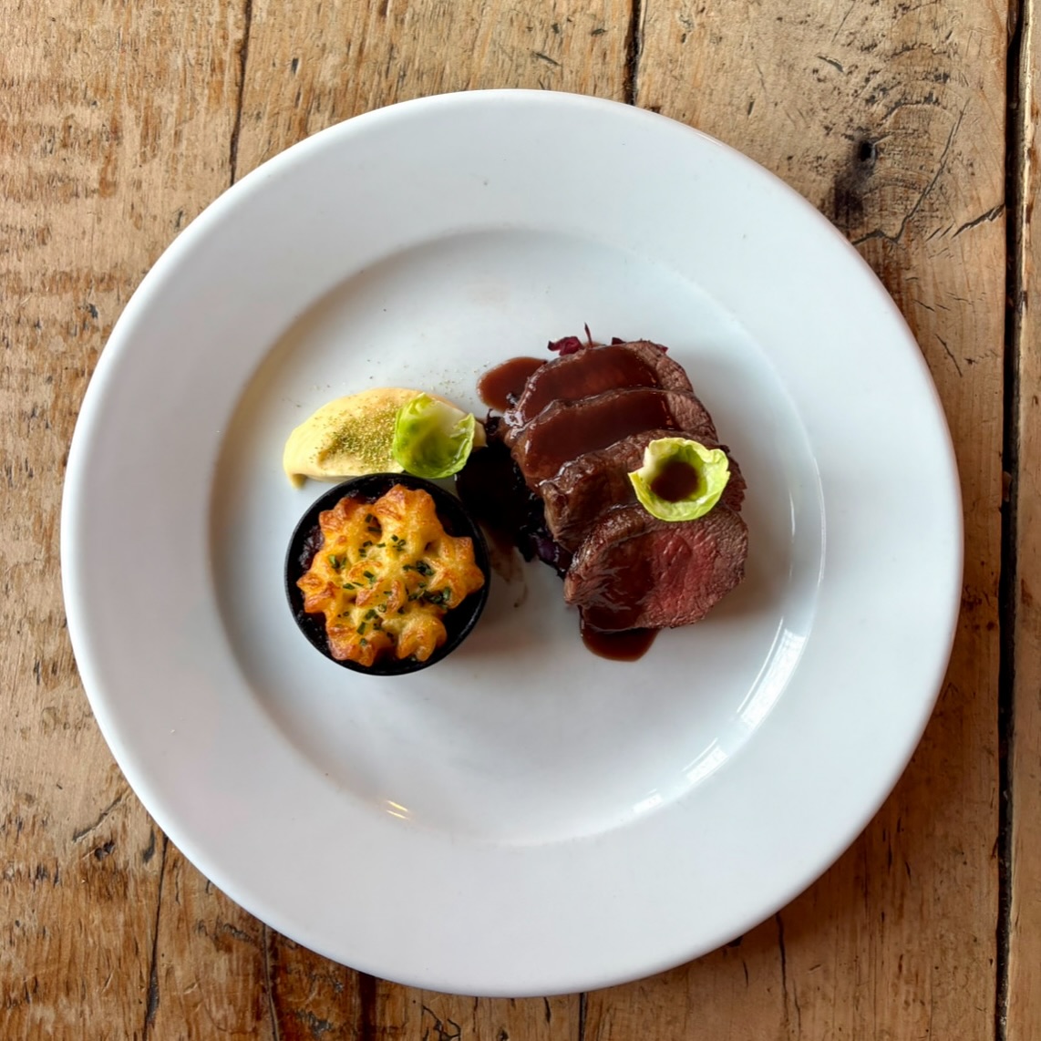 Exmoor Venison Loin with hunters pie, roast celeriac purée and braised red cabbage