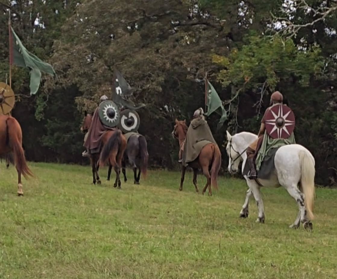 We've all heard it... dressage in its founding was to train horses for battle. To take young and fresh horses and turn them into fit and fierce war mounts ready for battle. But in how many situations do we truly get to put our modern war horse training to the test? How to we take dancing in the sand box and put it to use for what it was intended?
Ollie and I had the opportunity over the weekend to cosplay as riders of Rohan (yes im a big LOTR nerd) and even though this was a staged shoot, I got to put his training to use in so many more ways than I would have thought and it gave me such a different perspective and appreciation for what classical dressage truly is.
I was grateful for the warm up. Our gear was thick, heavy and made true to form. Extra layers, a solid metal helmet, thick leather armor... and even a beard 😆 seriously hindered my range of motion as a rider as well as my point of balance and ability to see around me. If he was responding to something outside of my vision I HAD to trust that there was something there or even something going on with the other horses and give him an aid to move on a seconds notice. And there were 11 other horses and riders, shields, spears and flags that also had to be accounted for. There were horses that spooked, shied, tripped and were over faced at times. Sometimes we had to leg yield to a horse, away from a horse, around dropped gear or a horse that stopped suddenly.
Were we fighting each other? Nope! But we had to take accountability for our horses and to everyone else around us. And at times there was a lot going on. Not to mention it was a first for many of us and our horses. I couldn't be more proud of how Ollie handled every challenge and worked with me. We truly were a cohesive team. Dodging horses, equipment and people with lovely collected lateral work and even a couple of unintended pirouettes.
Dressage without purpose seems to fall flat. It keeps us in this mindset of striving for perfection and possibilities of micro management. When dressage put to use as it was intended is powerful, light and explosive. It truly brings horse and rider together more than anything ever could