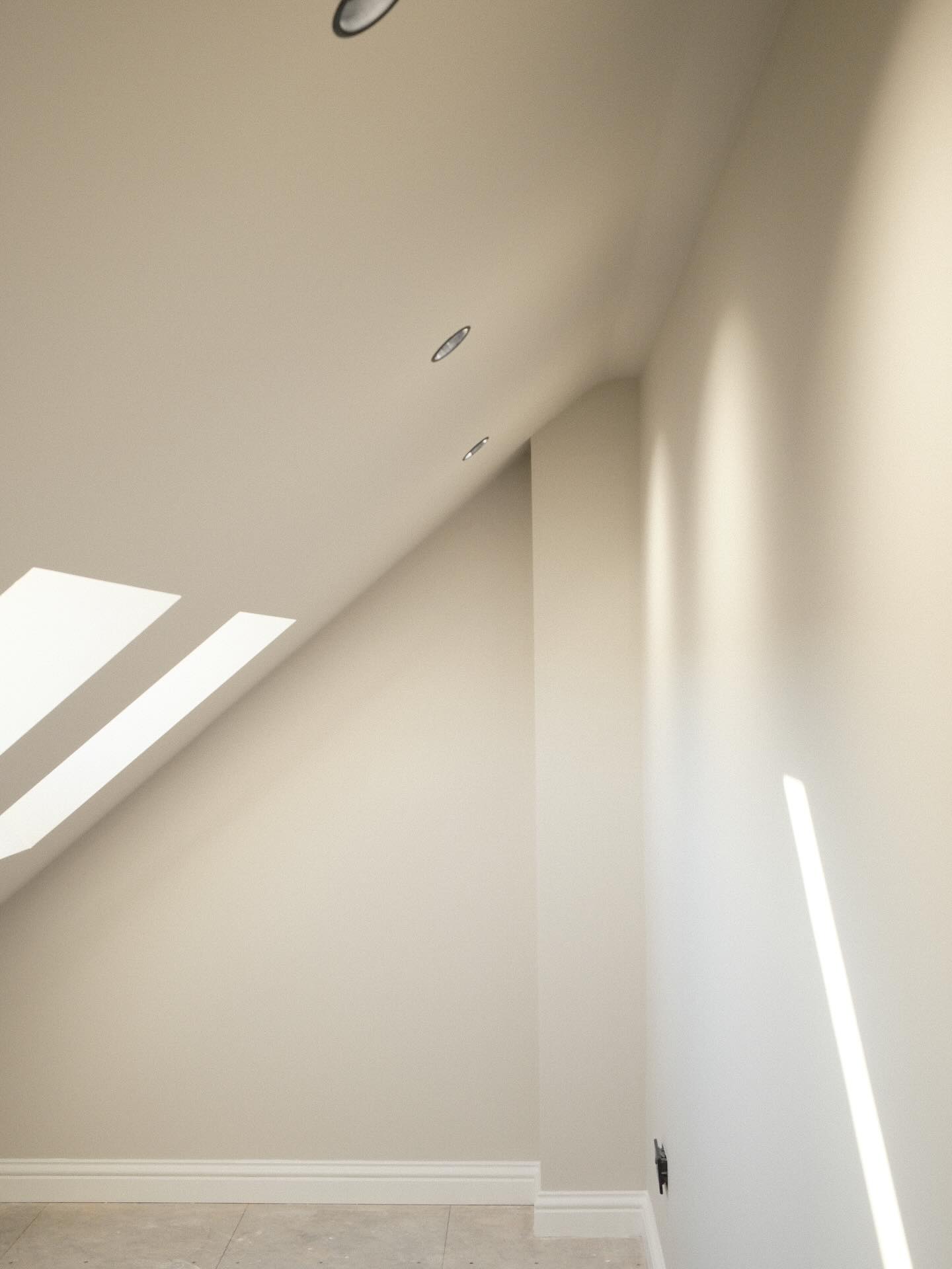 This recently completed loft conversion embodies a quiet sense of restraint - a space designed to feel both elevated and effortless. By colour-drenching the walls and ceiling, the scheme achieves a soft, seamless flow that visually expands the room while creating an atmosphere of calm continuity.
Lighting was kept deliberately understated, with recessed anti-glare spotlights providing a warm, diffused illumination that complements the muted palette.
At SOHO, we believe true refinement lies in the subtle - where tone, proportion and light work together to create spaces that feel balanced, lived-in and timeless.
SOHO Developments | High-end residential extensions, loft conversions & full refurbishments