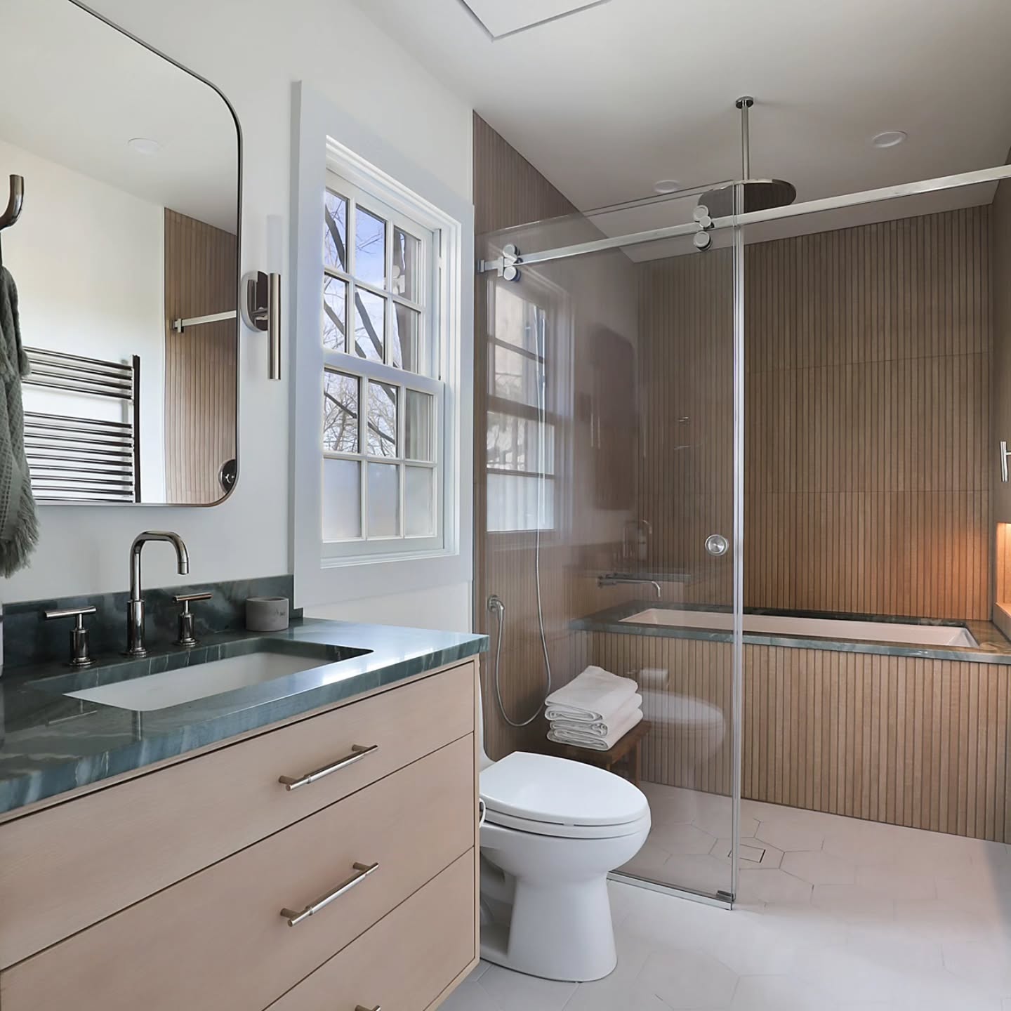 This bathroom had zero storage, a tiny shower, and a separate tub that didn’t work. We transformed it into one spacious wet room with a deep soaking tub + shower, a custom oak vanity designed to fit perfectly, and smart storage with a tower + recessed medicine cabinet. A zero-entry shower with continuous floor tile makes the space feel larger, while green marble + warm wood tones create a natural ambiance that ties it all together.
Custom design = no wasted space + endless possibilities.
📷@dannycooney
#LuxuryInteriors #CustomDesign #DesignBuild #WestchesterHomes #TimelessDesign #LuxuryBathroom #BathroomInspo #InteriorDesignGoals #HomeRenovation #CustomMillwork #InteriorDesignWestchester #RenovationGoals #DesignDetails ##bathroomrenovation #bathroomdesign #luxuryliving #housedesign