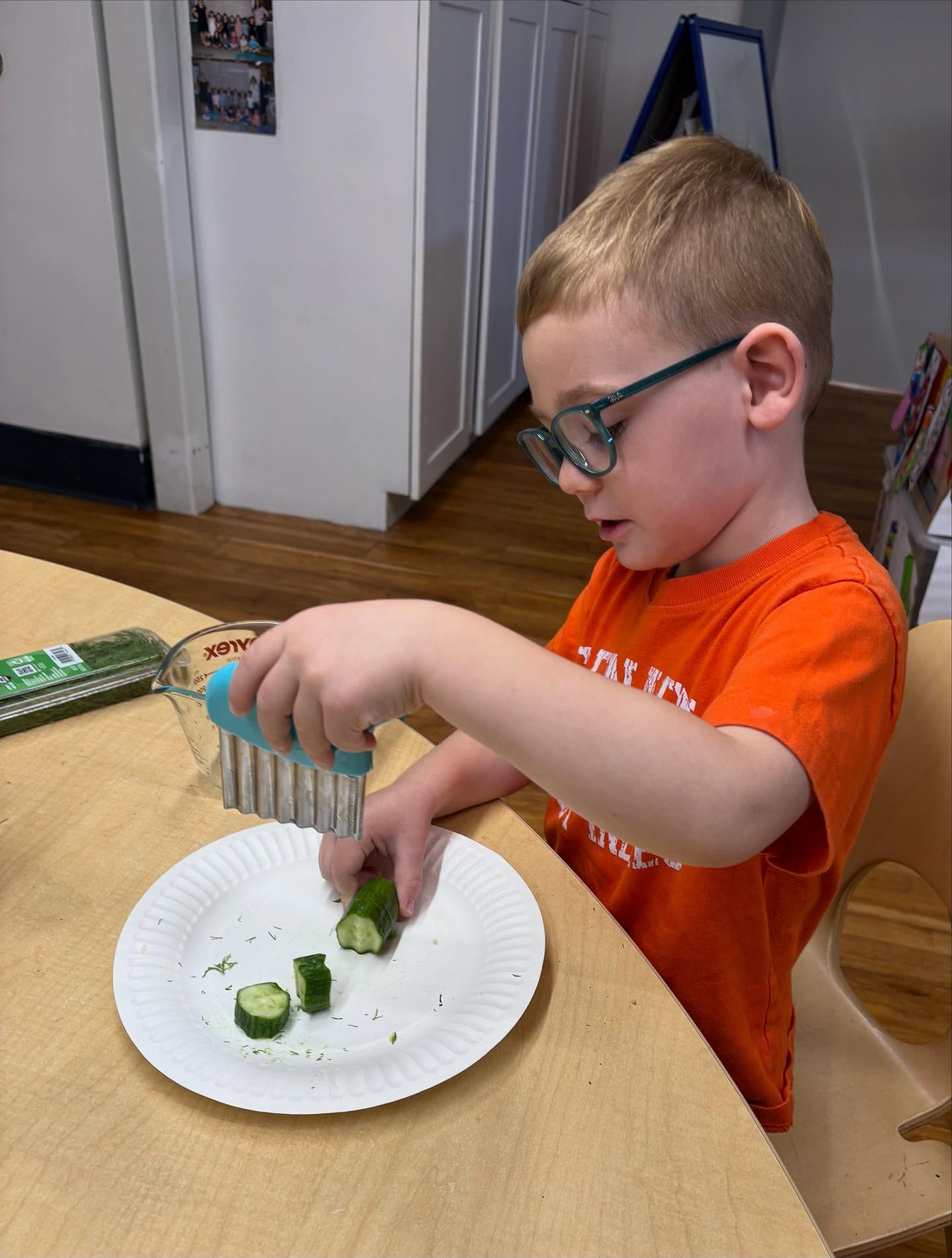 Yesterday, Kelly, Allyson & Jeanne's Fours sliced cucumbers and helped mix all the ingredients needed to turn them into pickles. As they worked, they used their senses to explore the different ingredients they were adding. "Dill smells like grass," declared one friend. Another discovery was that white vinegar and water might look the same but definitely do not smell the same!
For Tasty Tuesday today, the friends tried plain cucumbers and their homemade pickles and voted on which one they preferred. 🥒
#LCDS
#LearningCommunityDaySchool
#PlayBasedLearning
#SocialEmotionalLearning
#Preschool
#WestportCT
#FairfieldCounty
#CommunityBuilding
#PreschoolCooking
#TastyTuesday