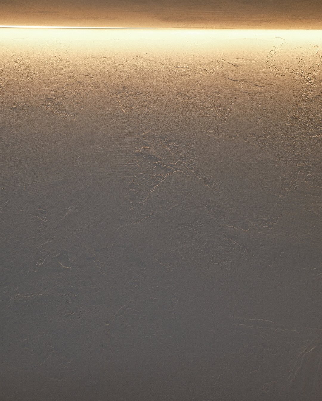 For this desk wall area in our Gerrards Cross project, we introduced a seamless microcement finish - chosen for its depth, tone, and tactile quality.
Microcement allows walls to carry warmth and movement without the need for excessive detailing. Its versatility makes it ideal for modern interiors, transforming dull, flat surfaces into refined architectural statements.
Our team is fully trained in professional microcement application, ensuring durability, precision and a flawless finish that stands the test of time.