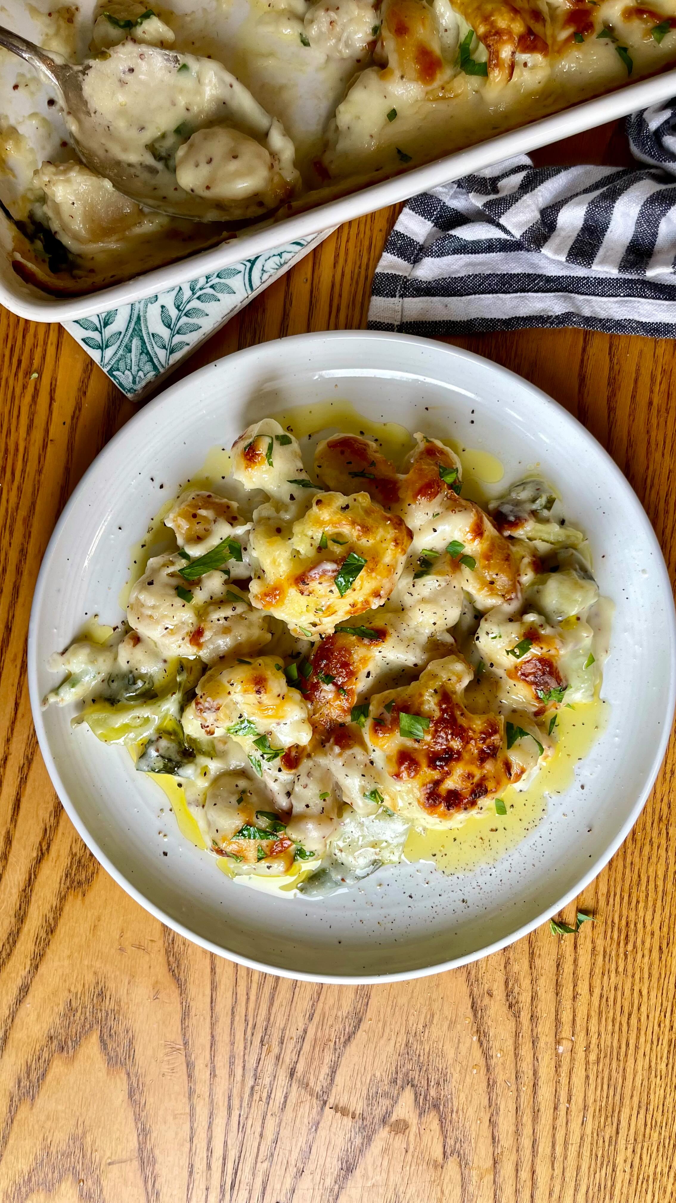 Double Cauliflower Gnocchi Cheese 🧀
Sometimes you just need something beige, delicious and comforting, and this recipe gives you just that whilst also being packed with veggies!
We’ve gone double cauliflower for the first of our autumn vegetable series.
This is a twist on the classic Cauliflower Cheese, using the leaves for extra fibre and nutrients, mustard and lemon for a deeper flavour profile, and @sunnyandlunaeats Cauliflower Gnocchi for an extra portion of veggies.
You’ll need:
1 small cauliflower with leaves, florets broken off and leaves roughly chopped
Sunny & Luna Cauliflower Gnocchi
50g unsalted butter
50g plain flour
500ml milk
100g cheese, grated
2 tsp whole grain mustard
Juice of half a lemon
Parsley and a dash of Extra Virgin Olive Oil to serve
Preheat the oven to 180c (fan). Bring a pan of water to the boil with some salt and add the cauliflower and leaves. Boil for 4 minutes and drain.
Melt the butter in a saucepan or milk pan and add the flour. Make a roux (easier than it sounds!) by whisking on a low heat until a smooth paste is formed. Cook for 2 minutes, then add the milk slowly, whisking all the time. Whisk regularly until the sauce has thickened, usually 3-4 minutes. Add half the grated cheese and the mustard, and whisk to combine until all the cheese has melted.
In a shallow baking dish, add in the cauliflower and leaves, plus a pack of Sunny & Luna gnocchi. Spread evenly and pour the cheese sauce over. You can leave a few gnocchi pieces sticking out, they will go brown and crispy! Sprinkle the rest of the cheese over the top.
Oven bake for 20 minutes, or until the top is as golden and crispy as you like! Serve with a bit of excellent quality extra virgin olive oil and parsley.
You can make this vegan by using your favorite plant-based milk, butter and cheese.