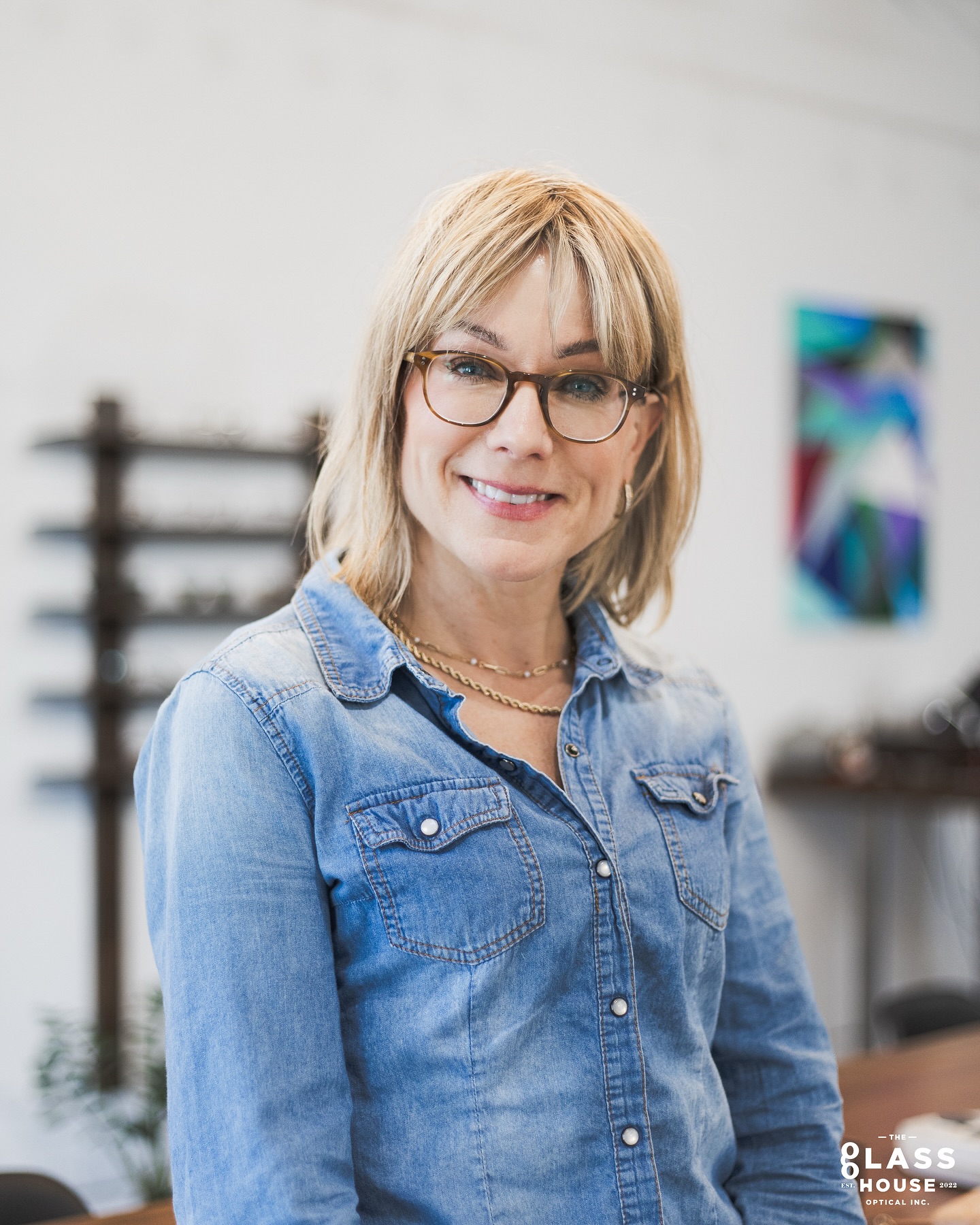 Here’s Tara in her new eyeglasses, the “Fairmont” by Oliver Peoples!
A timeless, and sophisticated frame suitable for any occasion. This soft square frame complements Tara’s face shape perfectly, and the warm sandalwood colouring provides contrast against her blue eye colour allowing it to pop beautifully!
Tara has a slightly higher prescription which can cause unwanted thickness around the perimeter of lenses, and weight. Choosing a properly fitting frame is of utmost importance not only for aesthetics, but comfort throughout the day.