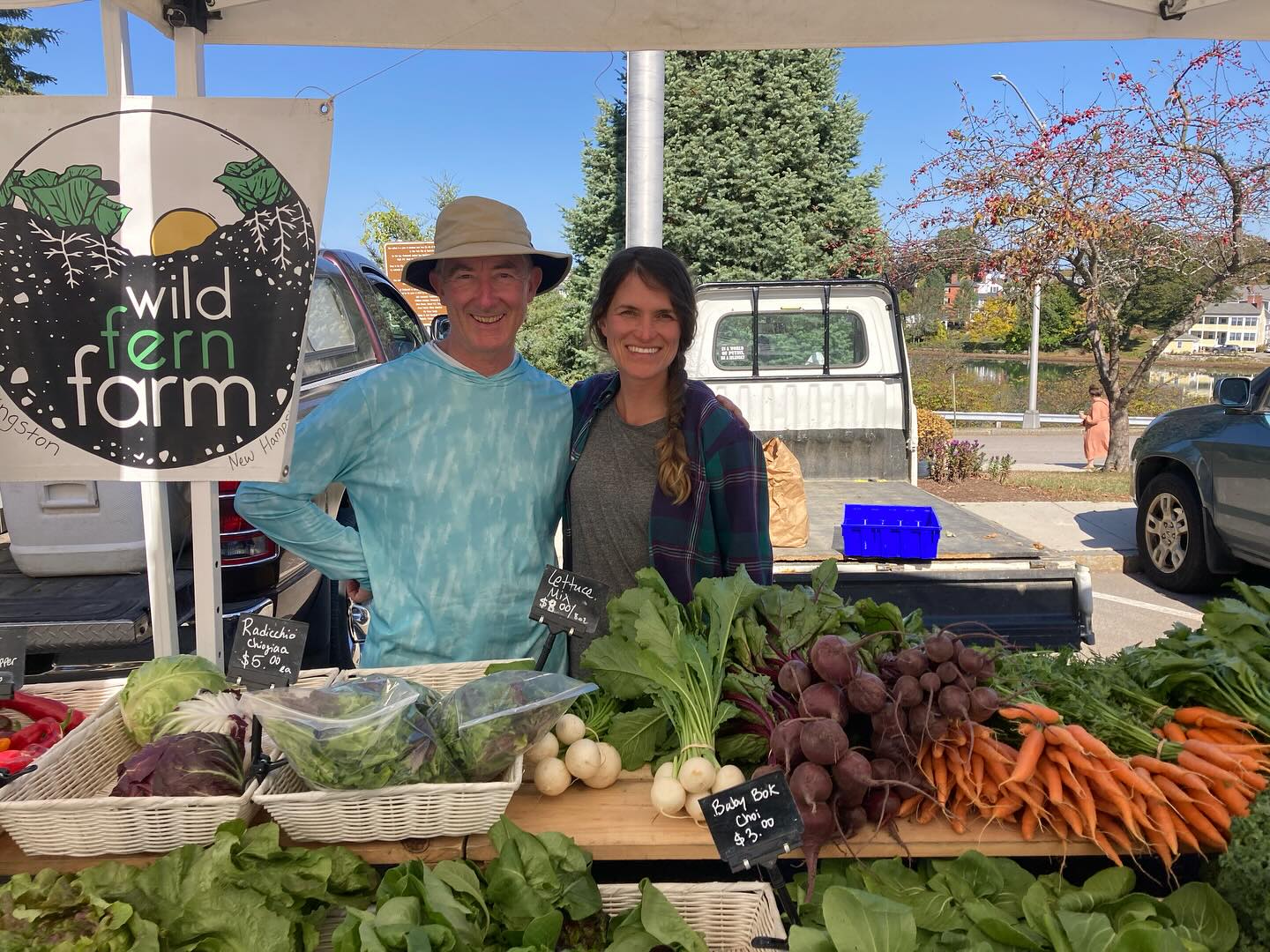 We have three more Saturdays left of the Portsmouth farmer’s market and we have a lot of food to show off this season of abundance!
Radicchio and baby ginger are clearly the stars at our booth right now and the new batch of carrots are so sweet and tender.
The first picture is of Dale and I (Liz). Dale is a farmer friend from up the road who offered to volunteer his time to help me at the market. Just because he wants to see young farmers succeed. He comes to the Portsmouth market every week, brings all the tents and tables and food that I can’t fit in my truck, does way more of the customer transactions than I do and just helps me out immensely. Farming can be done solo but it sure is better with a village 💕.
