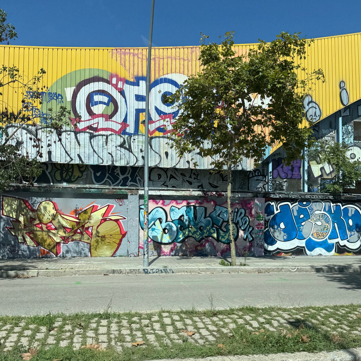 Very long Wall with all kind of Graffiti in Barcelona.