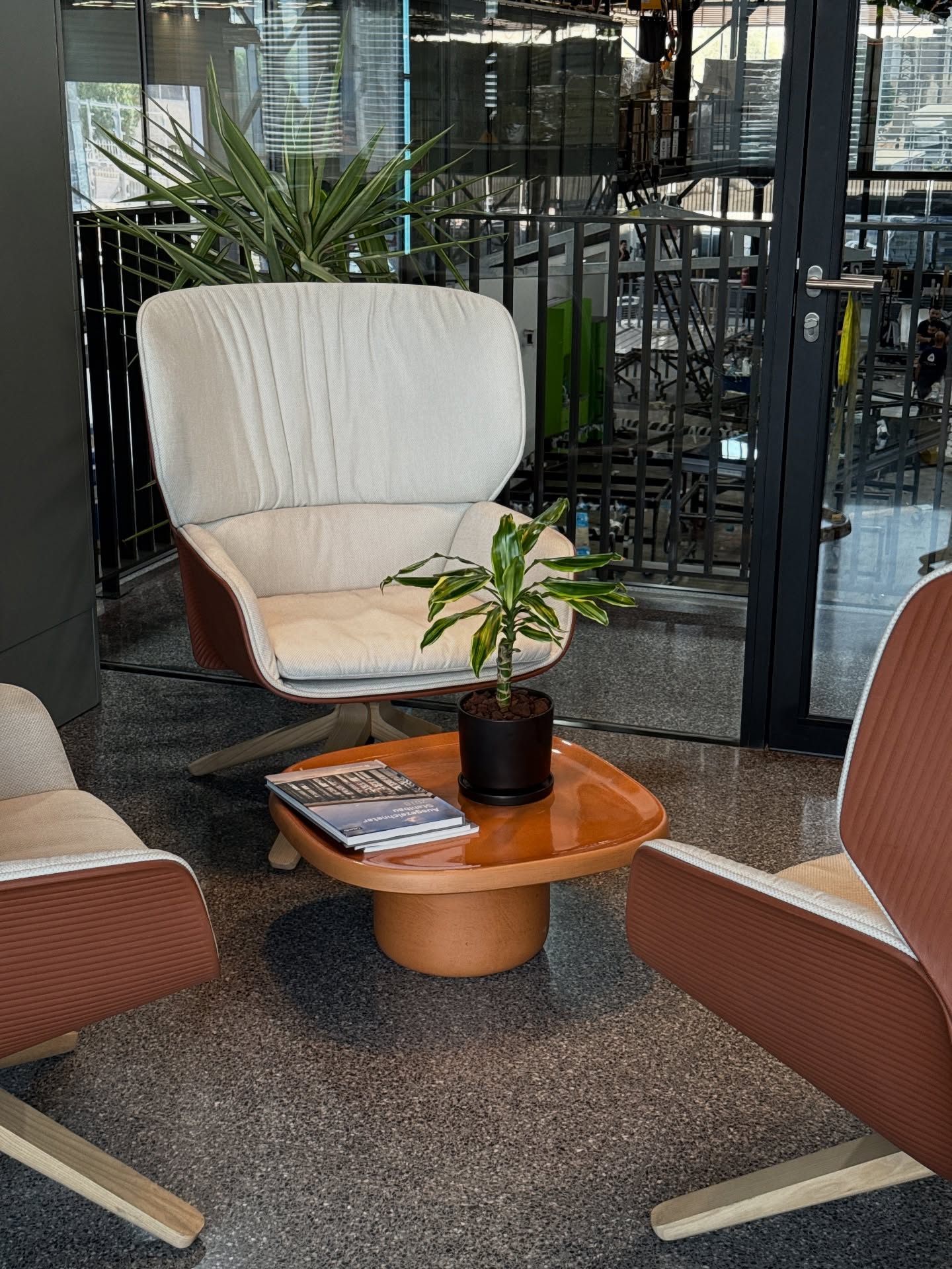 Office lounge area.
Grey terrazzo flooring, warm-toned furniture.