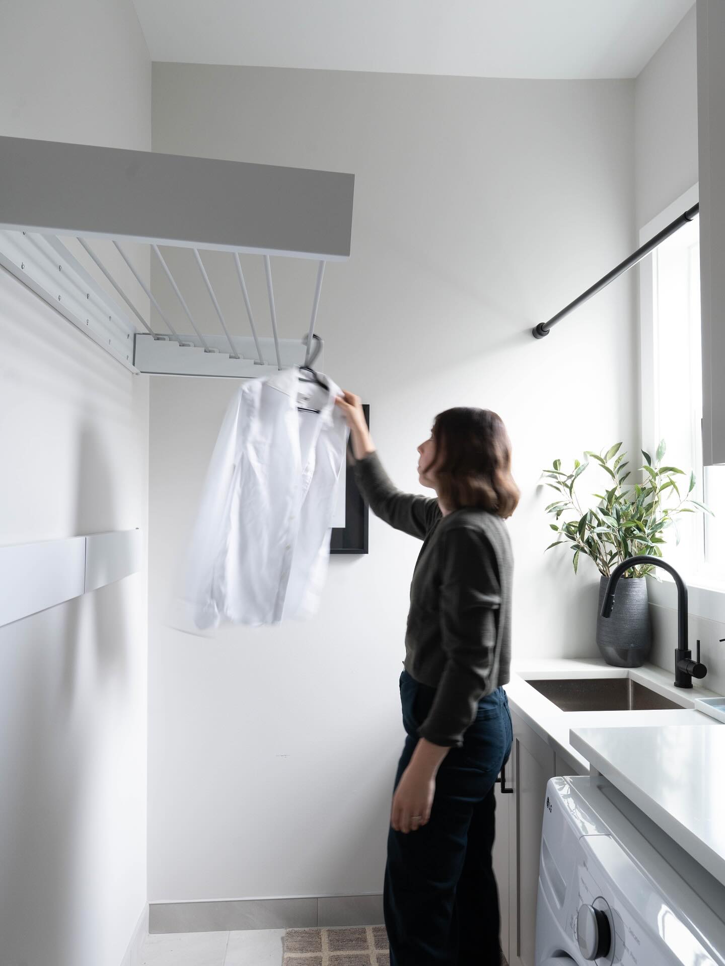 With a full house, these clients needed ample drying space, without compromising floor space in this narrow laundry room. These fold out drying racks do just the trick. When you aren’t using them, they sit flush to the wall, allowing for the most breathing room possible.
We work with our client through each room in their home to ensure we maximize functionality, while making it beautiful at the same time.