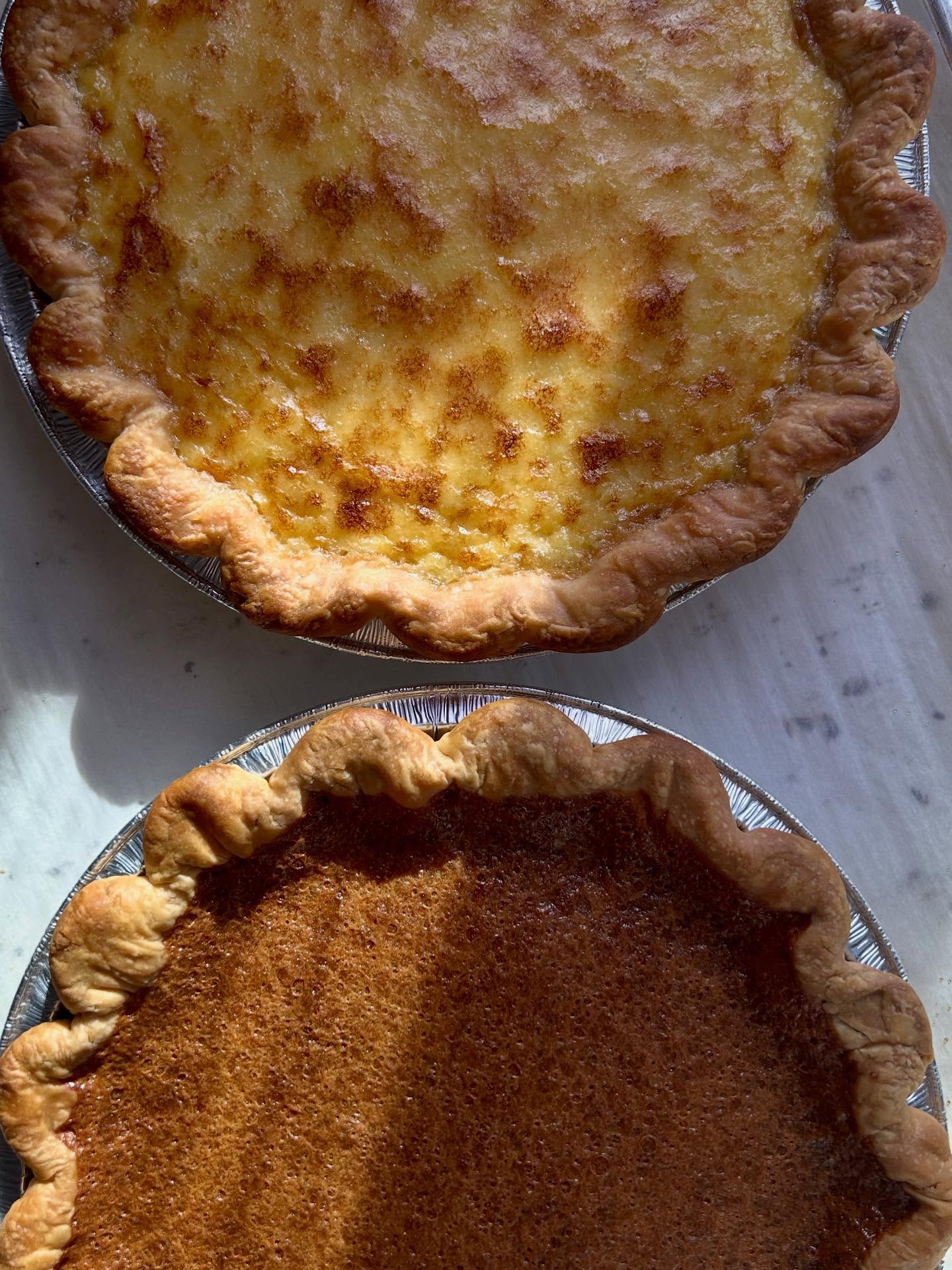 The pumpkin pies didn’t work out this morning, so I improvised with a brown sugar custard pie + buttermilk pie I’m bringing to @commongreens_bexley today ☺️
You will notice some price increases as we near the end of the season. I have once again waited too long to do this - I just don’t like doing it. But as I assess the current state of Ohio Pies, I can see there is truly no other option if I want to keep this business (and myself with it) afloat. I know we are all feeling the squeeze: I hope you will still be able to treat yourself with some delicious homemade pie ❤️
Along with the new custard pies I have a new hand pie today: @blueberriedalive blueberries + organic yellow raspberries! Plus candy bar pie returns (chocolate, caramel, peanut butter & pretzel 😋), crème brûlée hand pies, and of course lots more.
Thank you for continuing to support my small business 💕
-Emily