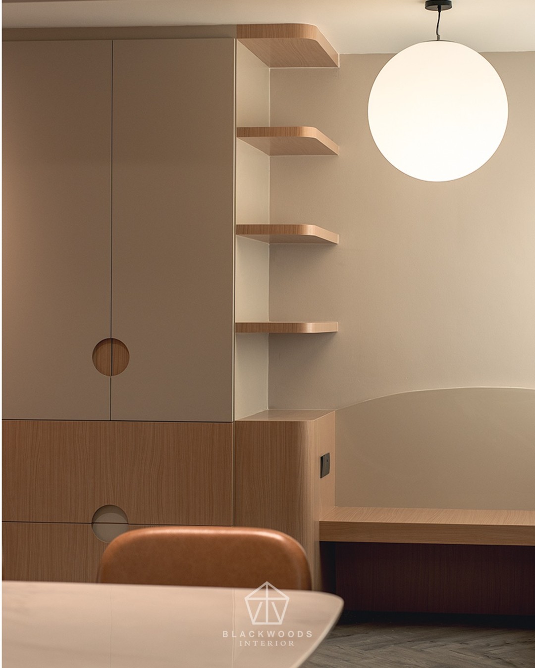 Minimalism, softened.
Circular cut-outs, curved shelves, and a glowing orb pendant bring playfulness into clean-lined cabinetry.
Warm wood meets muted tones, creating a dining corner that feels calm yet quietly expressive.
#blackwoods #blackwoodsinterior
#interiordesign #homestyling #sgliving
#modernhomes #renovationinspo
#calmspaces #cozycorners