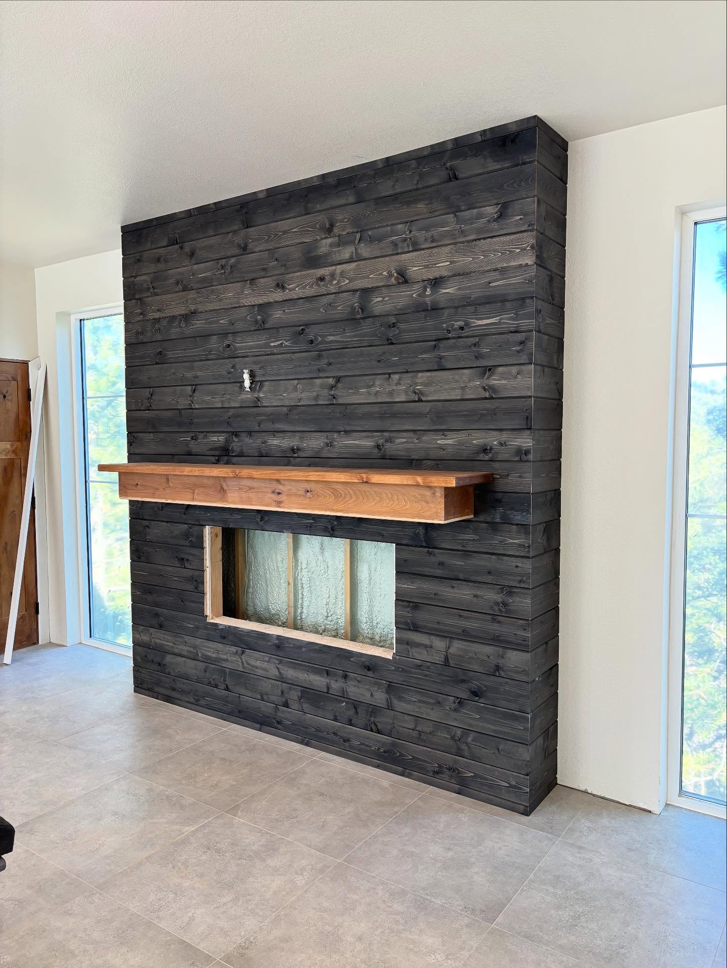 Fun little garage addition trim project. Stained T&G porch ceiling and fireplace bump out accent wall with alder mantel.