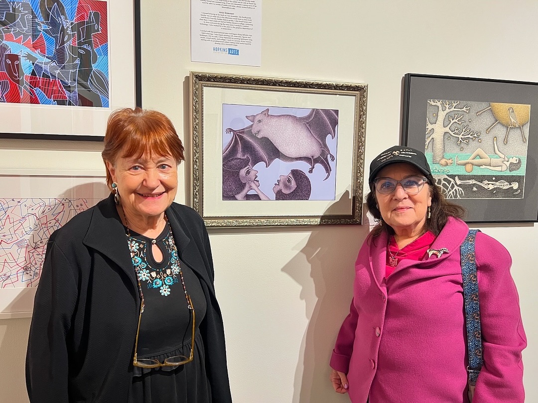 Or current show Collect Call 6, features art in the collection of local collectors! It’s up through November 9th, gallery hours: Thurs-Fri 10am-5pm, Sat-Sun 11am-5pm. Kathryn Hanna’s wall features the work of Gayle Novick: Kathryn met Gayle Novick about 10 years ago through a mutual friend. Gayle has been an artist for over 40 years. She was a member of the Women’s Art Resources of Minnesota (WARM) and will take part in the WARM 50th Anniversary Exhibition in April 2026. More recently Gayle has been a member artist at the Hopkins Center for the Arts.
Kathryn is drawn to the variety of styles that Gayle has executed over the years. Her work is primarily drawings and prints, but she has also made jewelry and note cards. Most works in this exhibit are for sale as Gayle has recently moved into assisted living. If you are interested in seeing more of her work for sale in a variety of media and styles, please contact the gallery. Gayle’s artist statement: I enjoyed drawing as far back as I can remember. My fourth grade teacher was an artist who in the afternoons would have us draw birds and flowers from the Golden Nature guides. I also loved horses and drew them. I took studio art and art history classes in college, continuing to draw and print during the many years I worked in medical technology. I also worked for a few years in the graphics department of a corporation.
I worked with fine point technical pens and began doing delicate cross hatch drawings. I also began painting with watercolor, figures and landscape, then into my particular style. I have expanded my painting techniques using acrylic, mixed medio, and collage. I work in a process driven manner, starting with no predetermined subject, letting initial marks hopefully develop into a successful image.