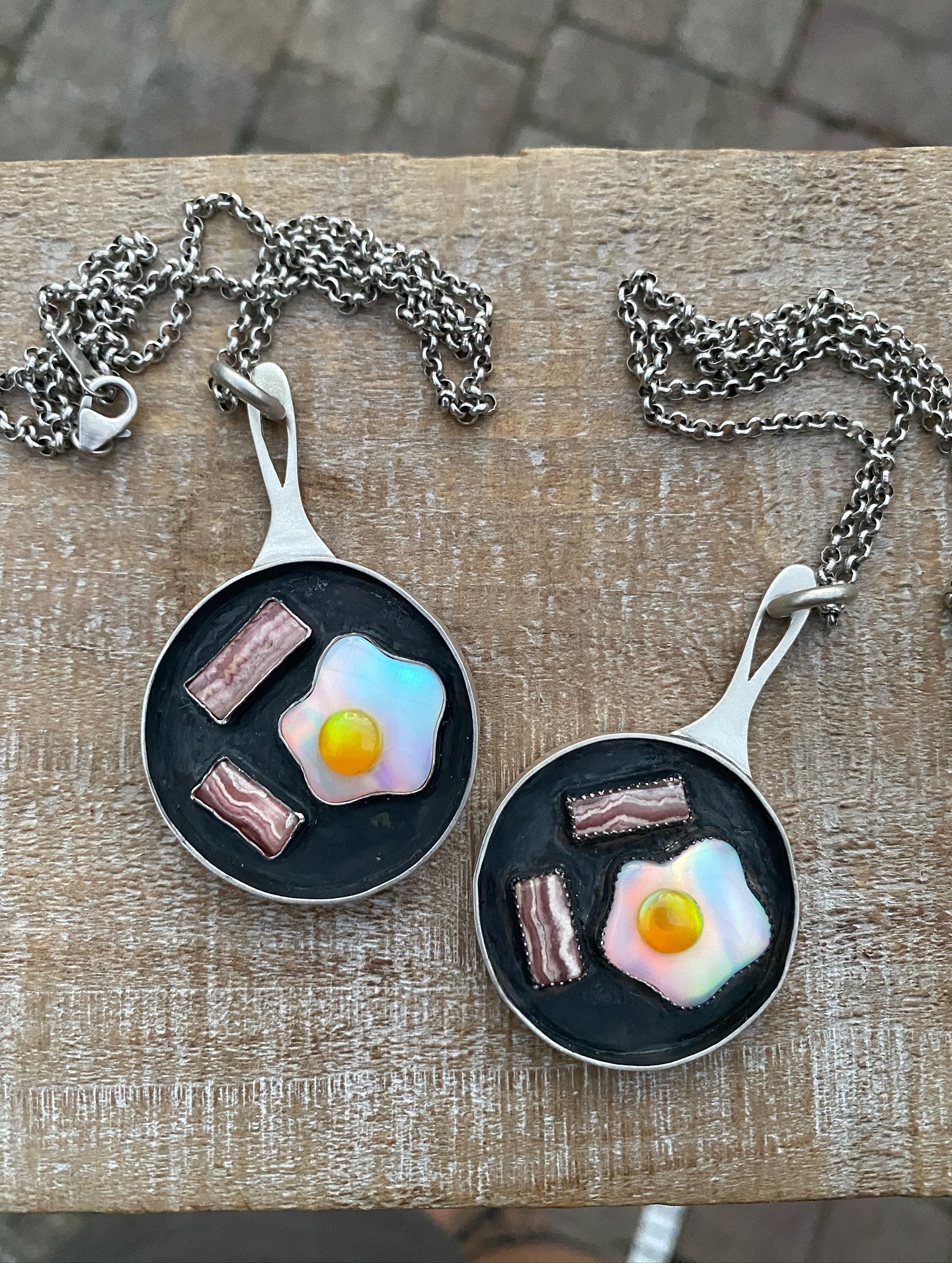 Breakfast of legends 🍳🥓 Sterling silver skillets with aurora opal eggs and rhodochrosite bacon — serving up a little sizzle & shine. ✨Hangs from a 20 inch sterling chain.
.
Available 10/26 @ 8 pm EST this weekend on my website, link in bio.