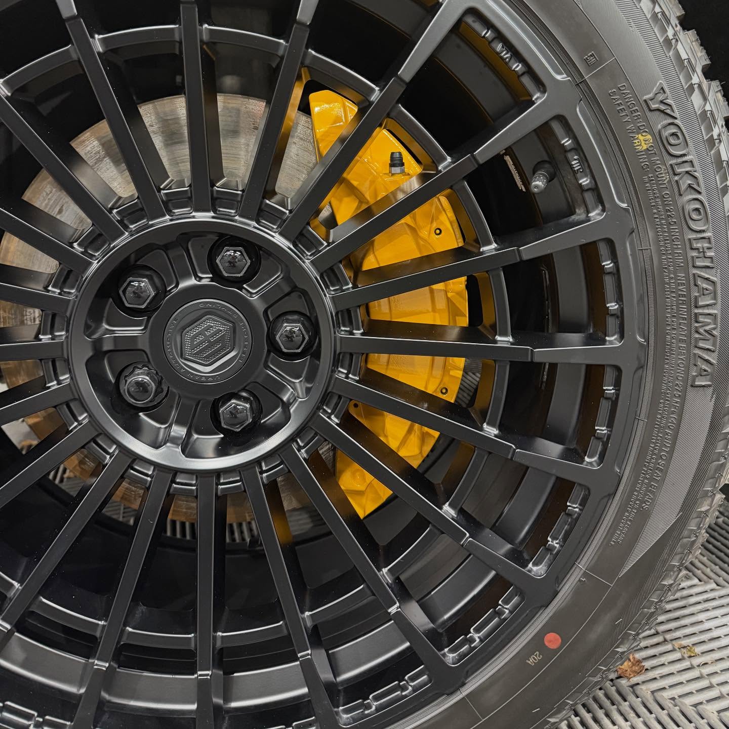 Adding a splash of colour to the calipers on this Urban Defender, which we have painted in Porsche racing yellow.