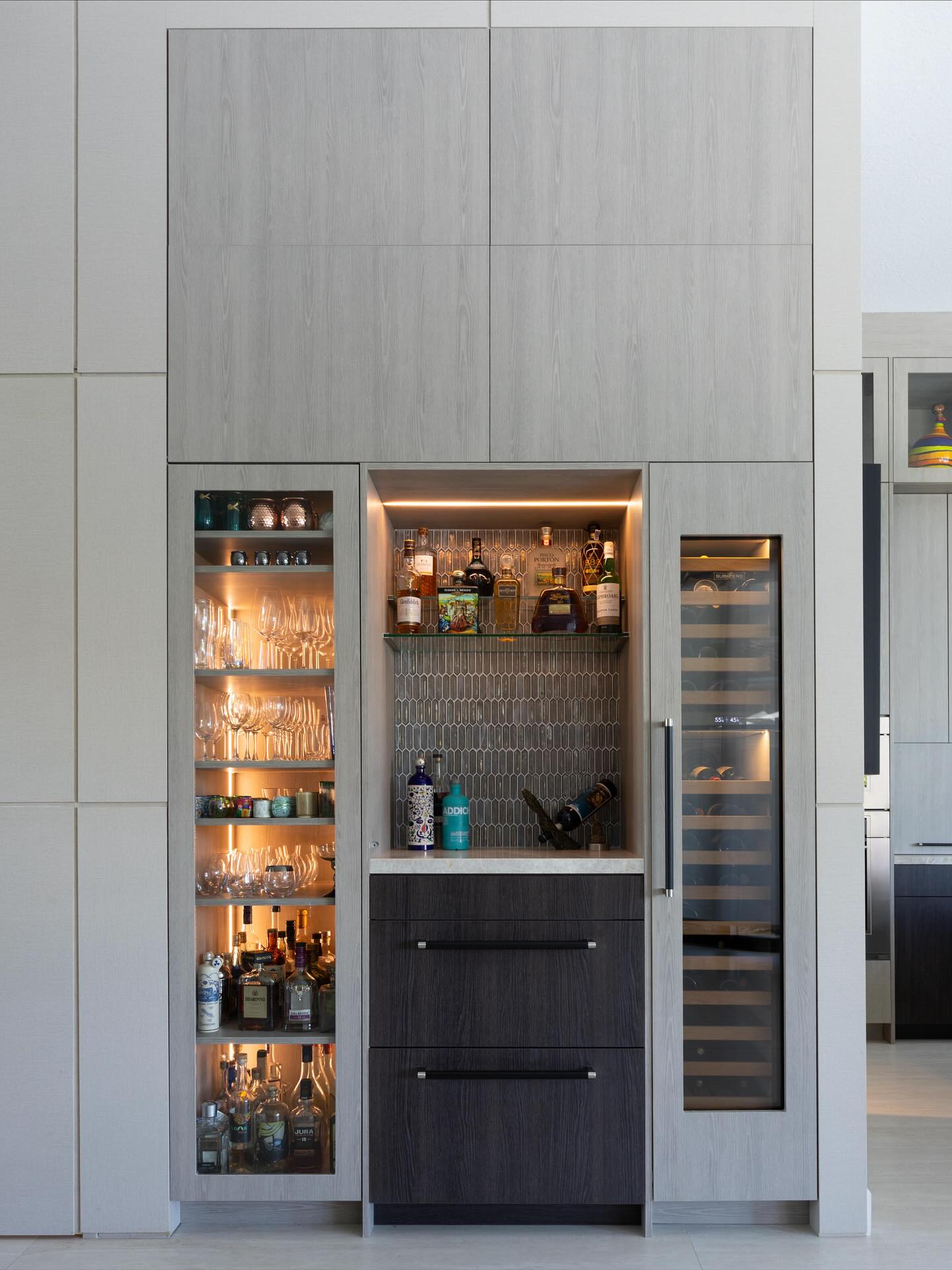 A tailored blend of texture and tone.
This custom bar area integrates function and beauty ⦠subtle wood contrasts, hidden storage above, and warm backlighting create a seamless extension of the kitchen.
At the center, @subzeroandwolf panel-ready appliances conceal a fridge and ice maker, while the vertical tile backsplash adds depth and quiet rhythm. Wall paneling flows continuously throughout the home, disguising storage above and framing this space as architectural as it is functional.
Softly illuminated glass shelving and the refined mix of finishes make this a design that truly lives with you. Modern, timeless, and thoughtfully composed.
Design: MLDesign Interiors
Millwork: @earthsourcedesign
Photography: @laurenalexis.photo
#BarDesign #HomeBarInspo #ModernLuxury #InteriorDesignStudio #CustomInteriors #WestonKitchen #DesignDetails #LuxuryInteriors #ModernCraftsmanship #PanelReadyAppliances #InteriorArchitecture #MLDesignInteriors #CraftedForLiving