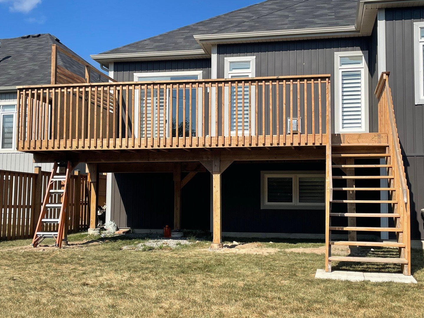 Another job well done 🎉
Deck spanning the full back of the house with a wide staircase and clean vertical rails.
Private corner up top, plus open space underneath for storage or shade.