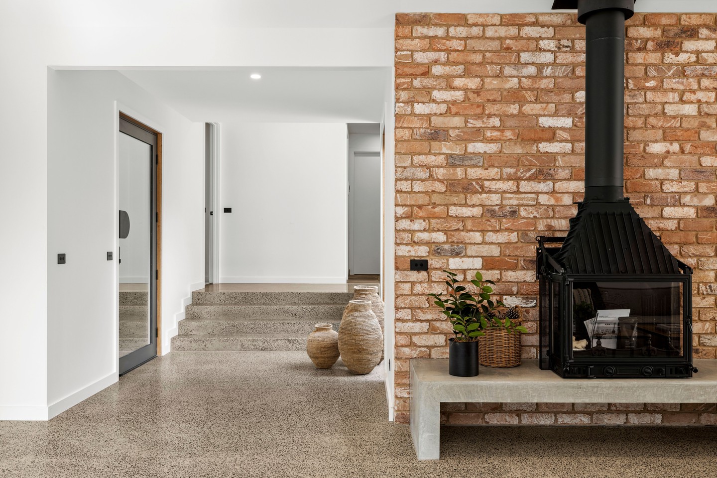 Polished concrete, painted plaster and recycled brickwork, a deliberate contrast of finishes in one space.
The look is capped off by a @chemineesphilippeaustralia fireplace, sitting pretty on a concrete hearth.
Design by @bradhooperarchitect
.
.
.
.
.
.
.
#buildtrend #buildtrendhomes #masterbuilder #sustainablebuilding #victorianbuilder #macedonranges #macedonrangesbuilder #australianarchitecture #architecturevictoria #interiors #contrastingmaterials #polishedconcrete