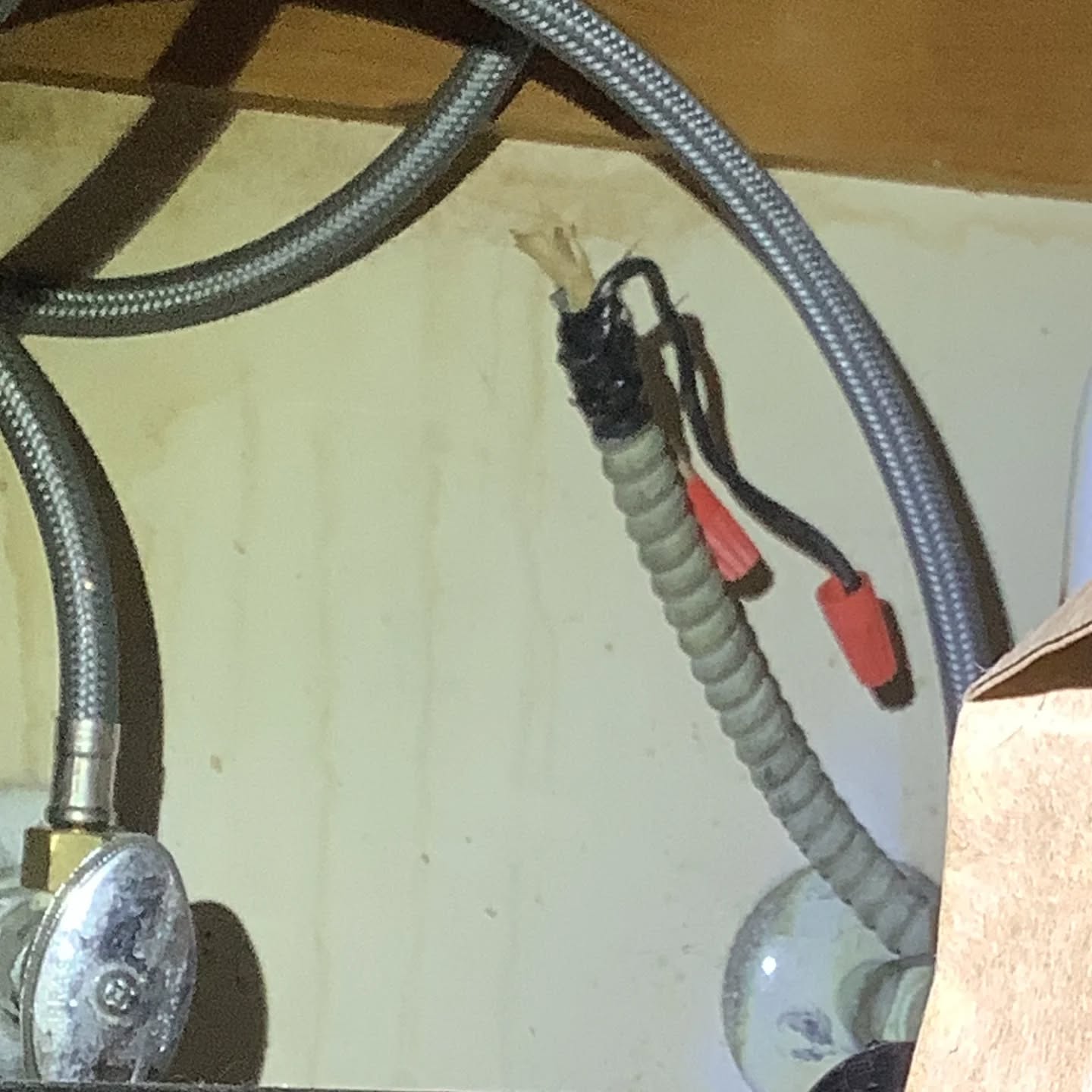 It's time for the defect of the day! Woot!
Today's defect is improperly terminated wiring. Here we have some metal clad cable with two wires sticking out with wire nuts on them. This is improper. The proper way to terminate this cable is to put it in a junction box with a cover. There will be wire nuts on the wires, just as they are here, but the junction box will be securely fastened to the wall, and the metal clad cable will be clamped to the junction box. This method of termination protects the wire ends from having the wire nuts fall off due to inadvertent contact.
The implication with the current method of termination is a shock and/or fire risk if the wire nuts were to come off somehow. It's also a code violation.
I hope you enjoyed today's defect of the day!!