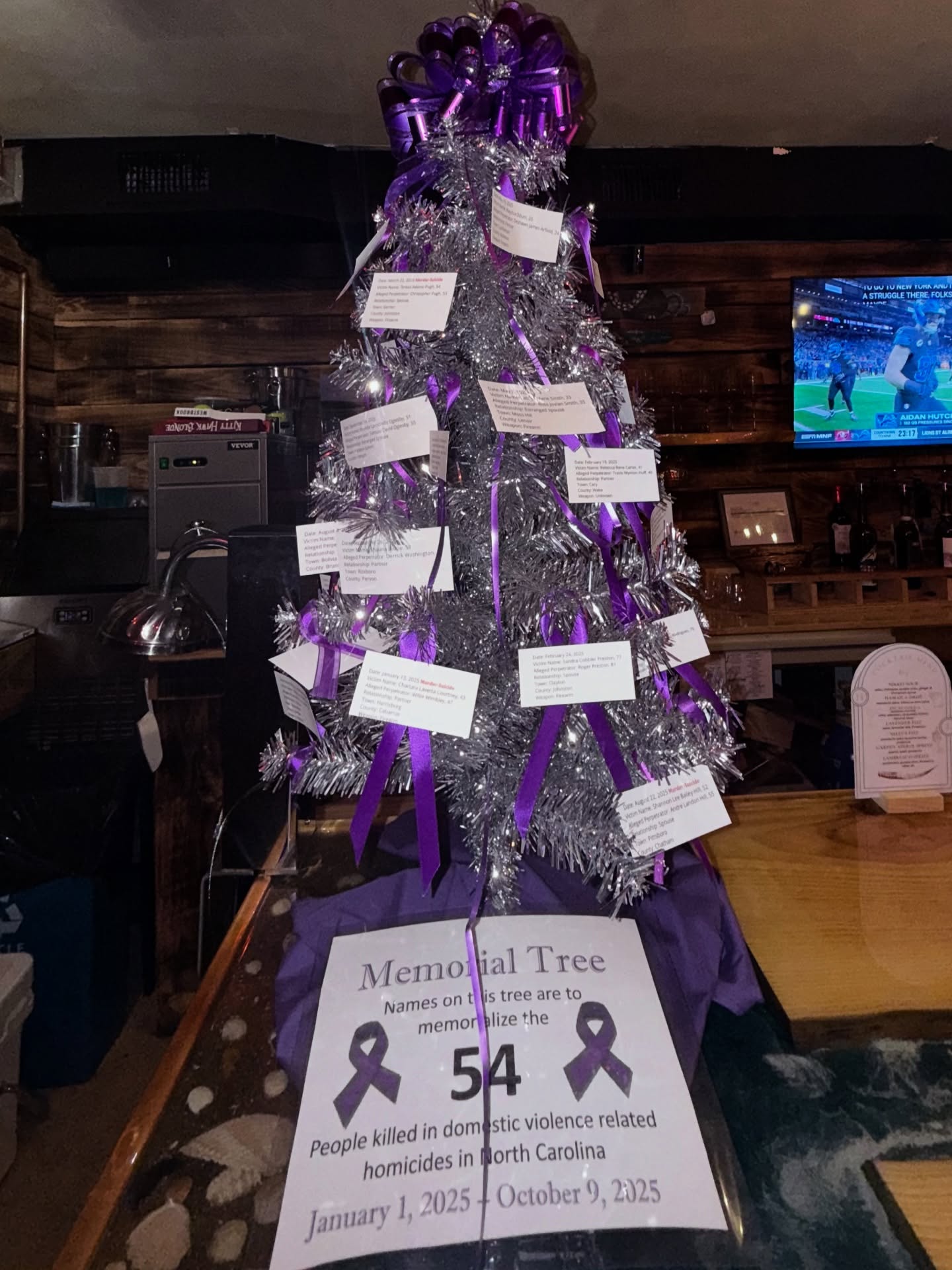 💜 This memorial tree stands as a poignant reminder of the 54 victims who tragically lost their lives to domestic violence in North Carolina from January to October of this year. Each ribbon represents a story, a life cut short, and a call to action for all of us.
This Domestic Violence Awareness Month, we invite you to join us at Huanchaco Lounge to honor these victims and raise awareness about the critical issue of domestic violence. Here, you’ll find essential resources, information about support services, and ways to get involved in our local hotline efforts.
Let’s come together to support survivors, remember those we’ve lost, and work toward a future free from violence. Your voice matters, and together, we can create change. 💜 @outerbankshotline
#EndDomesticViolence #SupportSurvivors #AwarenessMatters