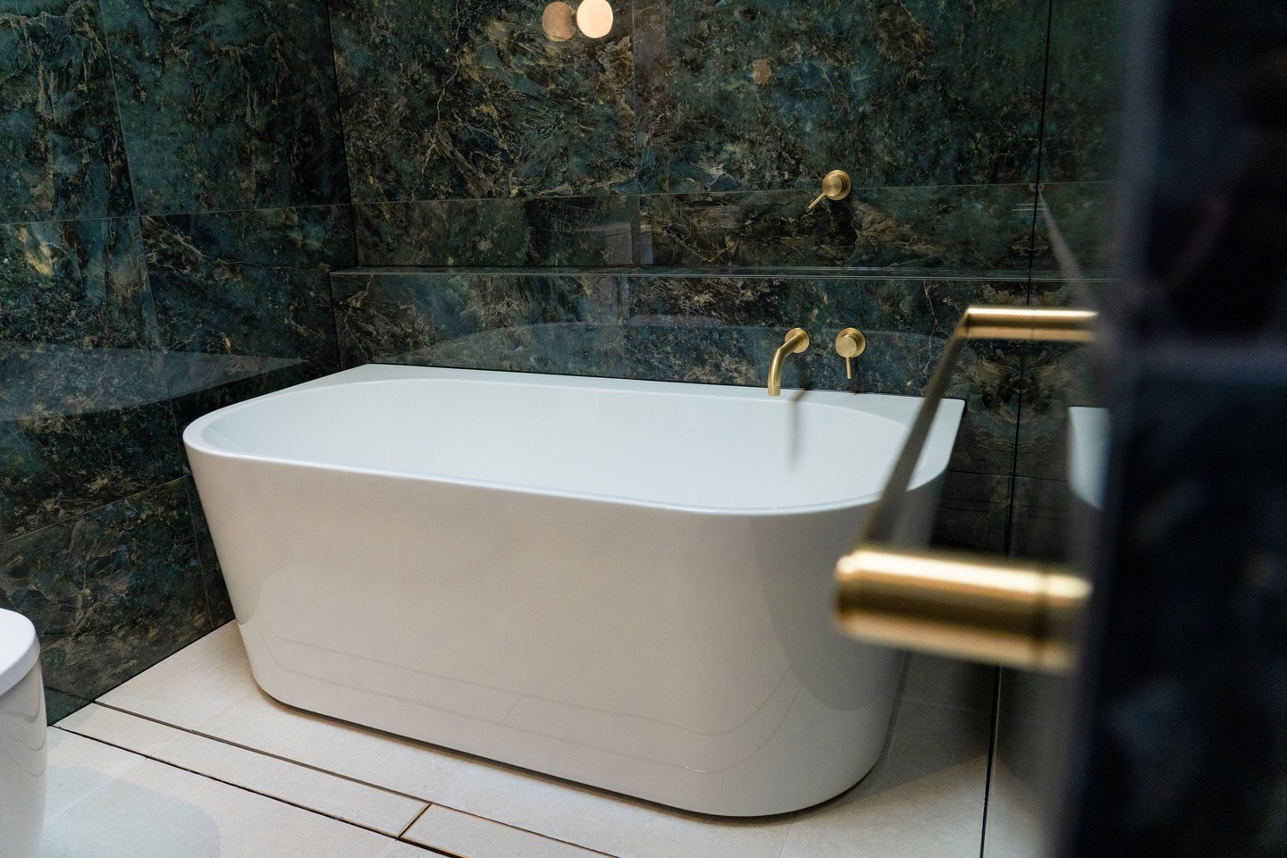 A statement bathroom at Lady's Pass, where deep green stone takes the lead, paired with brass fittings and a simple freestanding bath.
.
.
.
.
.
.
#buildtrend #buildtrendhomes #masterbuilder #sustainablebuilding #victorianbuilder #macedonranges #macedonrangesbuilder #australianarchitecture #architecturevictoria #ladyspass #bathroomdesign #interiors