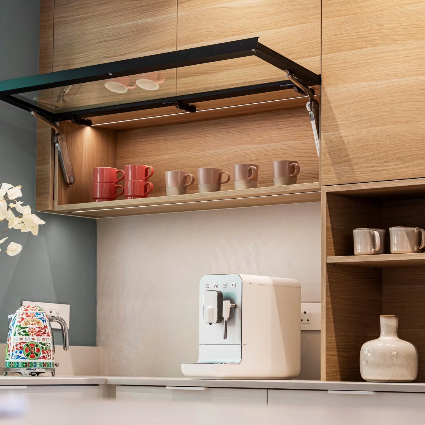 A dedicated coffee station designed as a quiet luxury moment.
Warm oak cabinetry wraps this space, with the lift-up glass door revealing mugs and glassware — organised and easy accessible.
Below, the Smeg coffee machine and the Smeg kettle sit like sculptural pieces, so the appliances become part of the styling rather than visual noise.
#CoffeeStation #SmegAppliances #GlassDoorCabinetry #KitchenJoinery #CuratedKitchen #RefinedDesign #InteriorDetails #MorningRituals #OakCabinetry #CoffeeAtHome
#camiinteriors #interiors