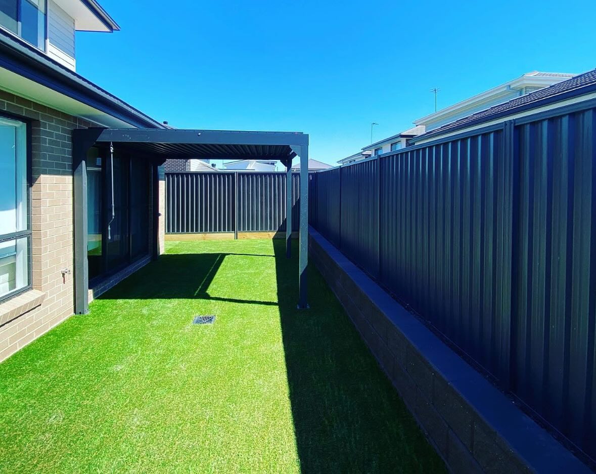 Retaining walls, synthetic turf, fencing and flat pack alfresco completed and ready to be enjoyed with no worries of water issues!