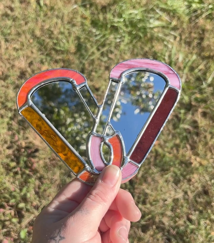 The full mirror version of our lesbian carabiner piece! We are currently finishing up 10 (!) of the regular version thanks to all of y’all - the most of any design we’ve done at one time! - but we also do this one as well, with a mirror in the middle to look upon your beautiful and gay self. 🏳️🌈