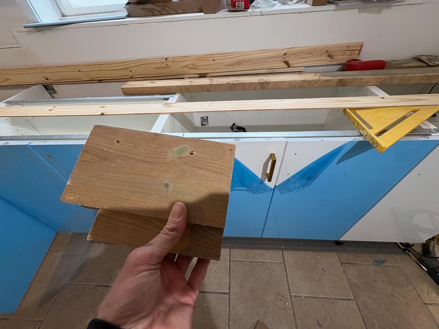 Using a quickly made jig to put gold handles on a inexpensive cabinet build to make it luxurious.