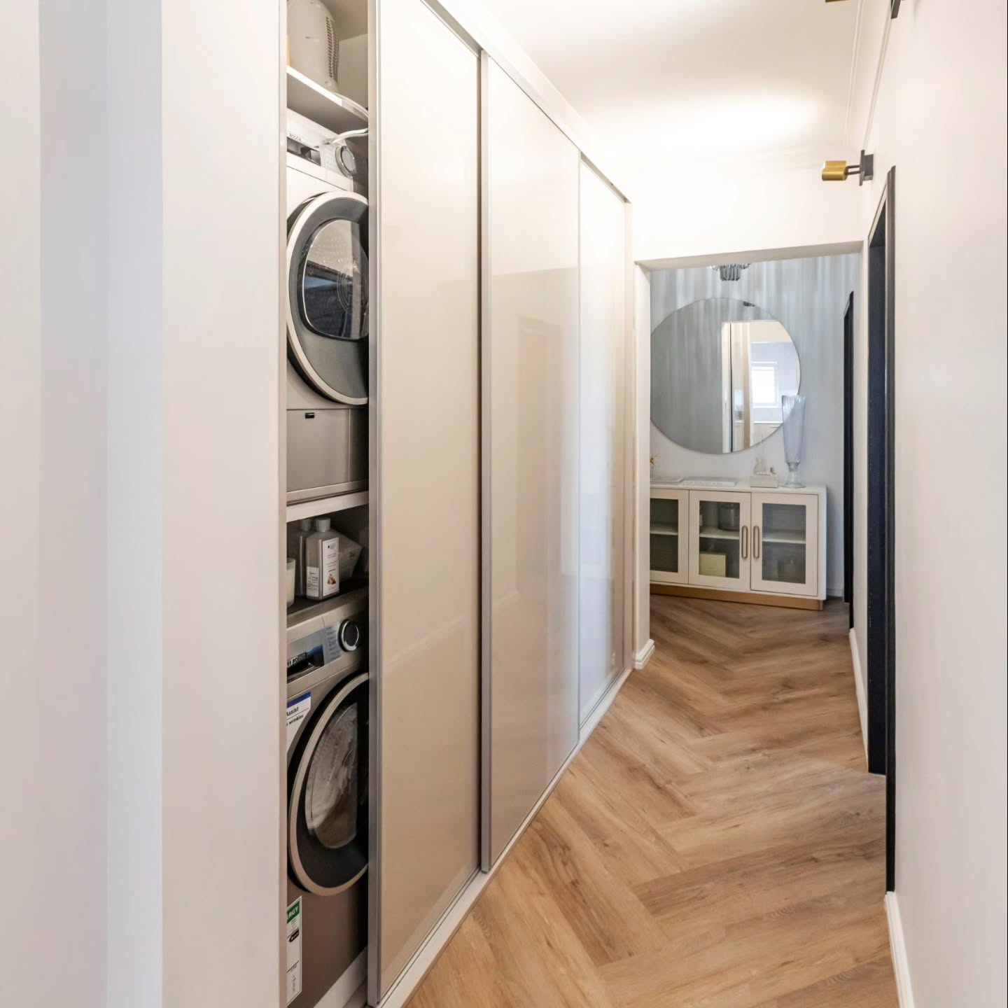 These sleek built-in units are finished with high-gloss sliding doors – creating a seamless, contemporary run of cabinetry that feels light, reflective and beautifully minimal.
Behind the panels sits a fully integrated laundry stack + utility storage… all concealed within the passage.
The beauty is in the invisibility – no visual noise, no hinged doors opening into a tight walkway, just clean lines and effortless function.
Photo credit @madrabbott
#builtins #slidingdoors #hiddenlaundry #hallwaydesign #interiorsouthafrica #integratedstorage #cleanlinedesign #modernhome #minimaldesign #smallspaceideas #joinerydesign #customjoinery #laundrycupboard #slidingdoorstorage #compactliving #hallwaystyling #storagegoals #hiddenappliances #cabinetrydesign #camiinteriors #designinsouthafrica #homeinteriorideas #designerstorage #functionaldesign #organisedhome #builtindesign #customcabinetry