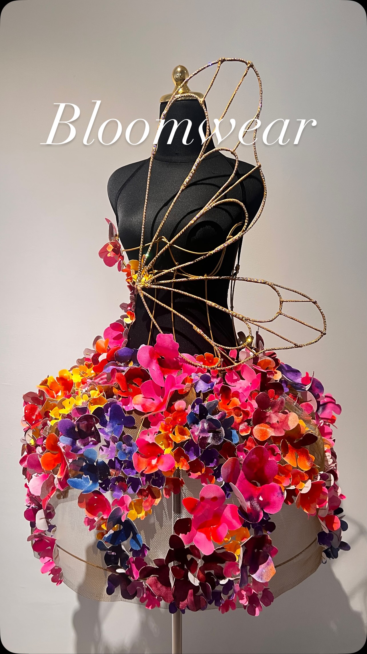 Bloomwear, 2025
Sculptural Art Installation
Mixed media
Dura Ki Hana x Dura Z
—
We’ve all been there. Somewhere between collapse and creation, fixing ourselves with tape and stubborn grace. Bloomwear was born in that space.
It began with wires and petals, but really, it was a dare — to make something louder than the silence I’d learned to live with. To wear joy, not just feel it from afar.
We, women, know this language too well. Rebuilding beauty from what once bent us. Every petal I wired, every curve I shaped, was a small defiance, a wink to every version of us that ever thought she was too much, too fragile, or too late.
The corset holds form, the petals rebel and somewhere between structure and surrender, we find joy again. Not the tidy kind. The loud kind. The glitter-on-your-fingers kind.
I made Bloomwear to remember what it feels like to breathe in colour again. To play. To dare softness.
Because sometimes, art isn’t something we make.
It’s something we become.
This art installation is a collaboration between my sister and I. #a4artfair #durakihana #bloomwear #gardenofhopes #mixedmedia #sculpturalart #artinstallation #artandfashion #xordinary
@a4artfair @___xordinary
30th October - 2nd November 2025 @gmbb.kl