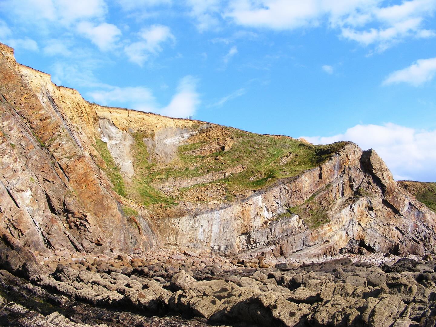 Stunning large-scale folds in the cliffs just south of Bude.
These flysch sequences are fantastic, and the exposures in the 50 m high cliffs are really impressive. The thickest sandstone beds are around 6-7 metres thick!
They represent major submarine landslides, that could have been triggered by seismic activity at the time.
Flysch is the traditional term for a broadly fining upwards sequence of sandstones and mudstones, deposited from turbidity currents (underwater avalanches) on submarine continental slopes.
These layers of sedimentary rock were originally deposited in the Culm sedimentary basin during rifting around 320 million years ago, in a shallowing ocean basin as more sediment was dumped in it.
Its source isn’t fully resolved, but is probably from a landmass somewhere to the north. It is stratigraphically known as the Bude Formation.
These rocks were buried and folded as Variscan continental collision progressed northwards throughout the Carboniferous.
Cornwall was effectively squeezed together like an accordion in a mountain chain for over 70 million years!
This caused the inversion, or expulsion if you like, of the Culm Basin sedimentary rocks.
This is controlled by the full graben geometry the Culm Basin and pre-existing structures in basement rocks.
#budeformation #flysch #seismic #sedimentary #structuralgeology #tectonic #tectonics #variscan #widemouthbay #cornwall #cornwallcoast #cornishcoast #cornwallgeology #cornishgeology #igcornwall #walkingcornwall #explorecornwall #lovecornwall #lovegeology #geology #geologyrocks #geolife #geologist #geologistsofinstagram #learninggeology #geoadventure #exploregeology #geologicalwonders #geologyfieldtrip #geologylife