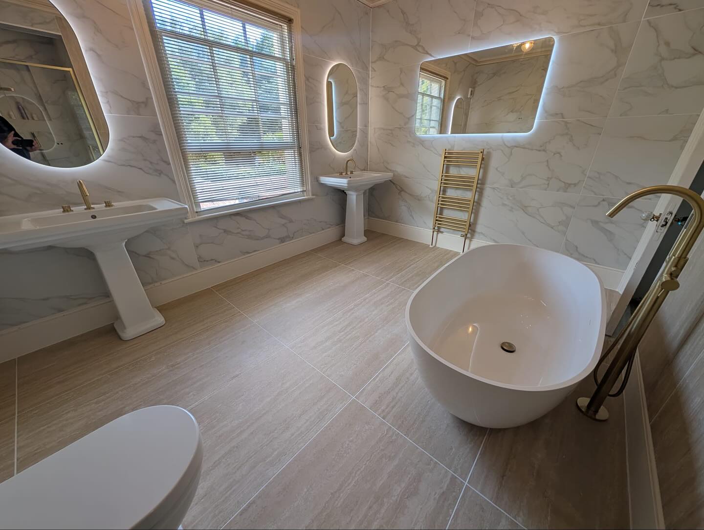 Another beautiful bathroom renovation completed in Guildford by our man James at @aquipped ✅📍
This project created an elegant bathroom with a mixture of golden marble walls, warm stone features and brushed brass accents to create a relaxing yet timeless aesthetic🤩
Swipe to see the how the design came to life - from our CAD to reality ✏️🗒️
This room features:
A wonderful Mist freestanding bath from our friends at Waters Baths of Ashbourne 🛁✨
Stunning Brassware and radiators from Crosswater’s MPRO range ⭐️
HiB’s Arcane Pill and Curve mirrors to bring a warm aesthetic to the room 🪞
Merlyn’s Arysto Sleek hinge door with inline panel and Level25 slimline tray, stylish and practical! 💫
GSI’s Classical pedestal basins and R2’s Langford close coupled pan to tie modern and traditional styles together 🏛️
The tiles we’ve used are 1200mm x 600mm porcelain slabs, great for ease of cleaning with minimal grout lines and perfect for making a room feel more spacious. On the walls we have Calacatta Gold Marble complemented by Realstone Blanco Vein on the floors and the fluted Blanco Decor as a feature behind the bath to bring a warm soothing aesthetic to the bathroom 🧡✨
@hib_bathrooms @watersbaths @merlynshowering @r2bathrooms @farmiloe_gsiceramica @gsiceramica @crosswater_uk
#bathroominspiration #bathroomdesign #bathroominspo #interiordesign #bathroomrenovation #bathroomdecor #bathroomvanity #bathroomtiles #bathrooms #bathroomsofinstagram #bathroomsofinsta #bathroomstyle #luxury #luxurybathrooms